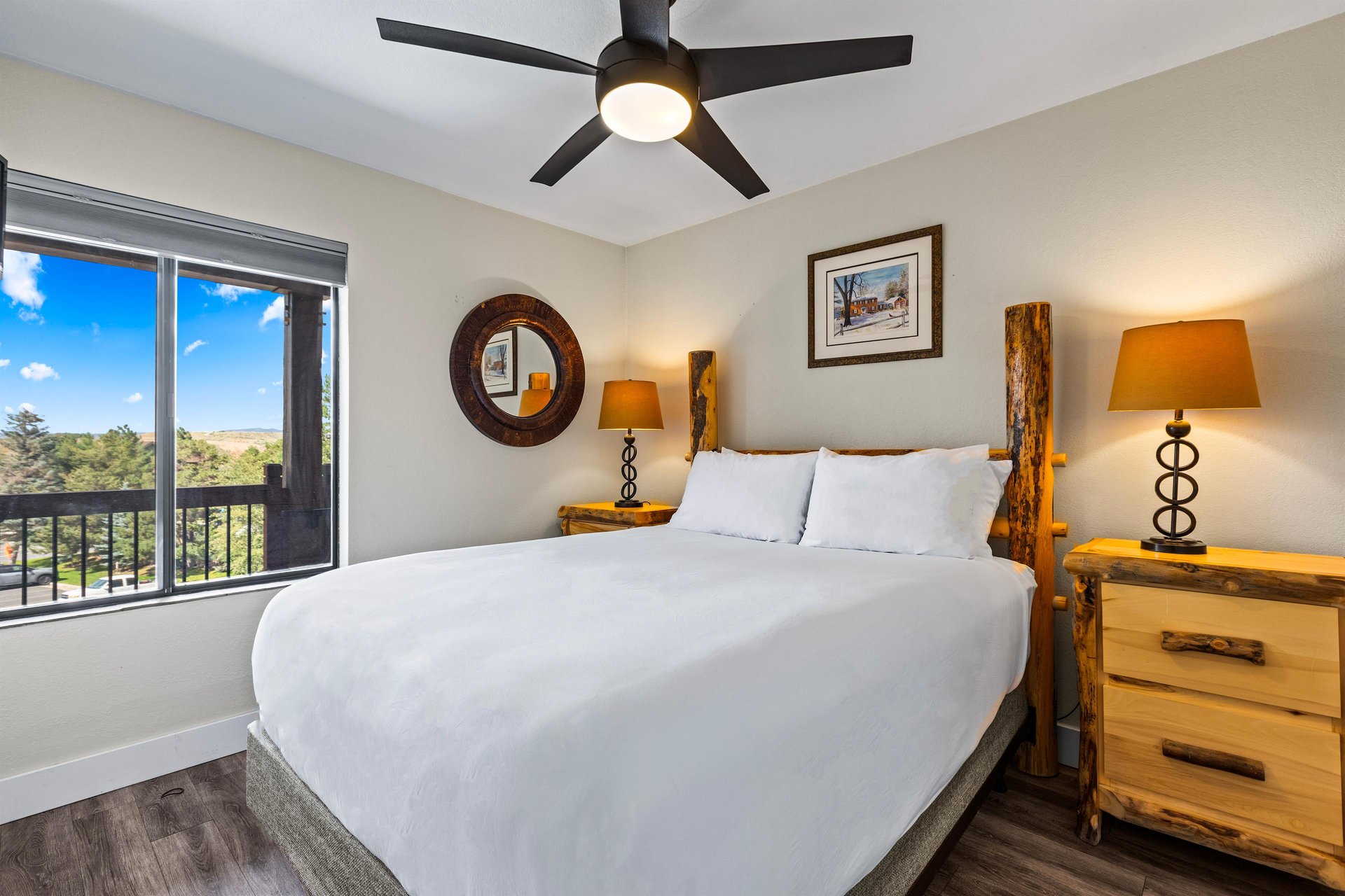 The bedroom with a queen size bed and a wooden bed frame.
