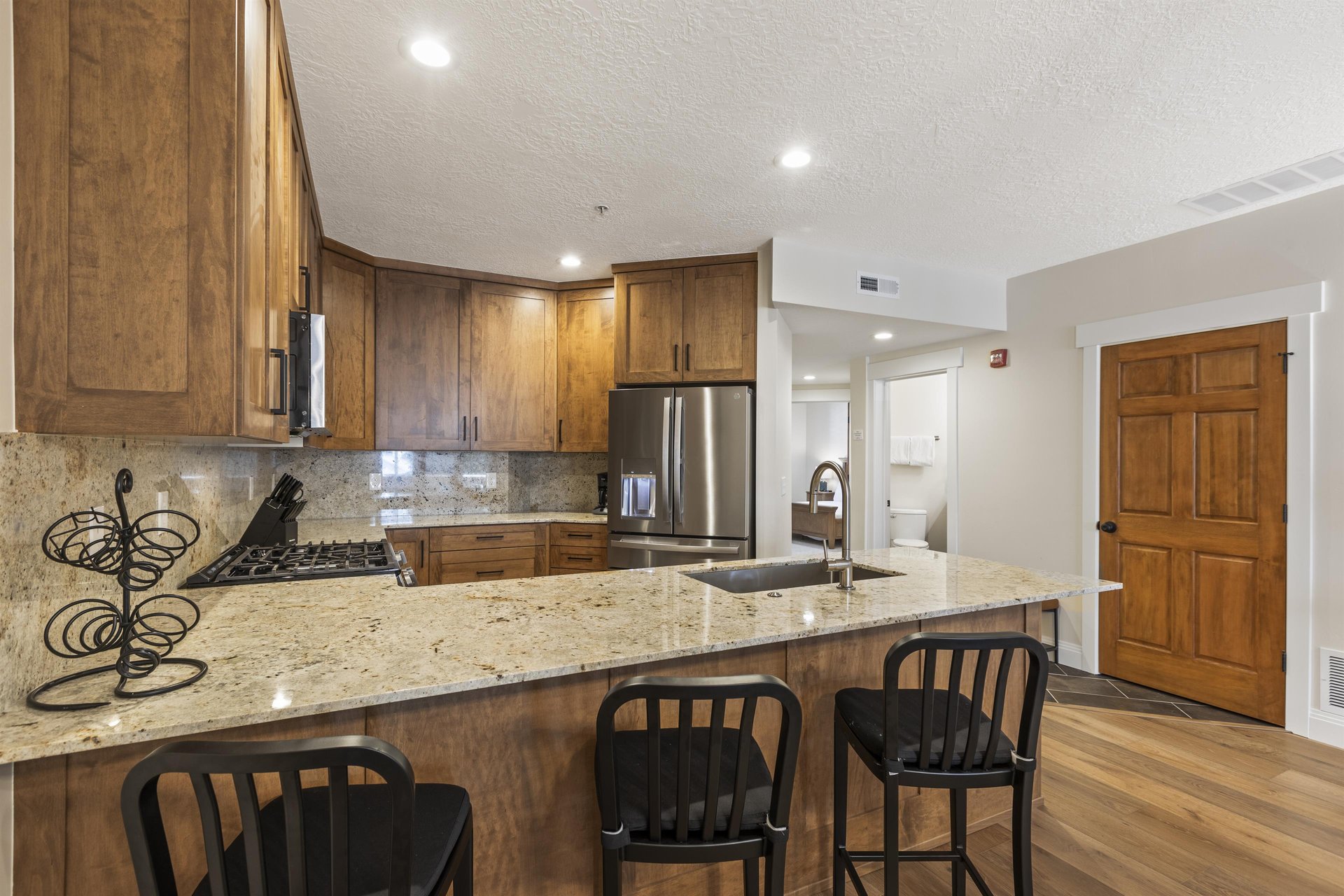 The wellequipped kitchen has a breakfast bar with seating for three.
