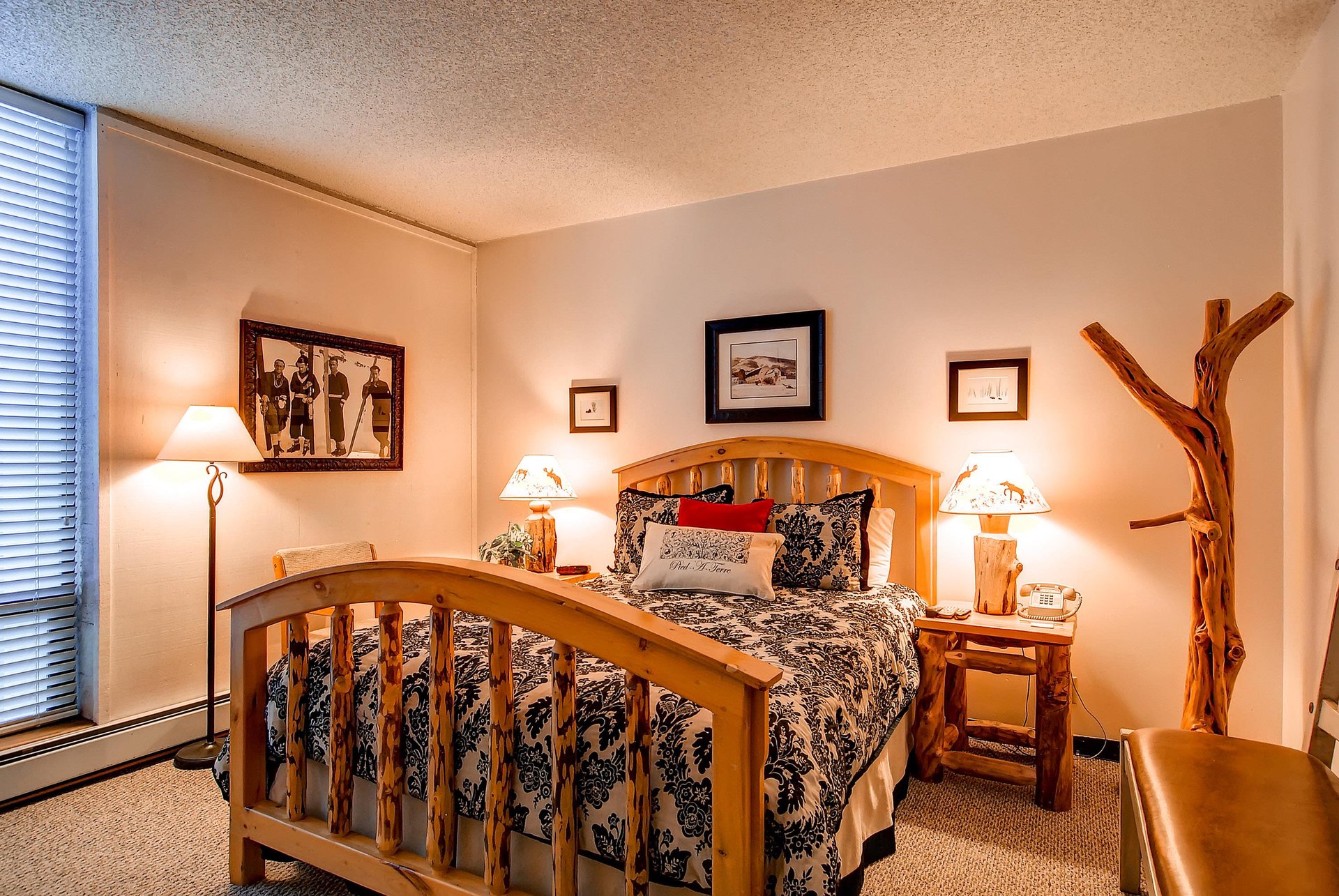 The main suite with a queen bed and nightstands with cozy lamps to light the room.