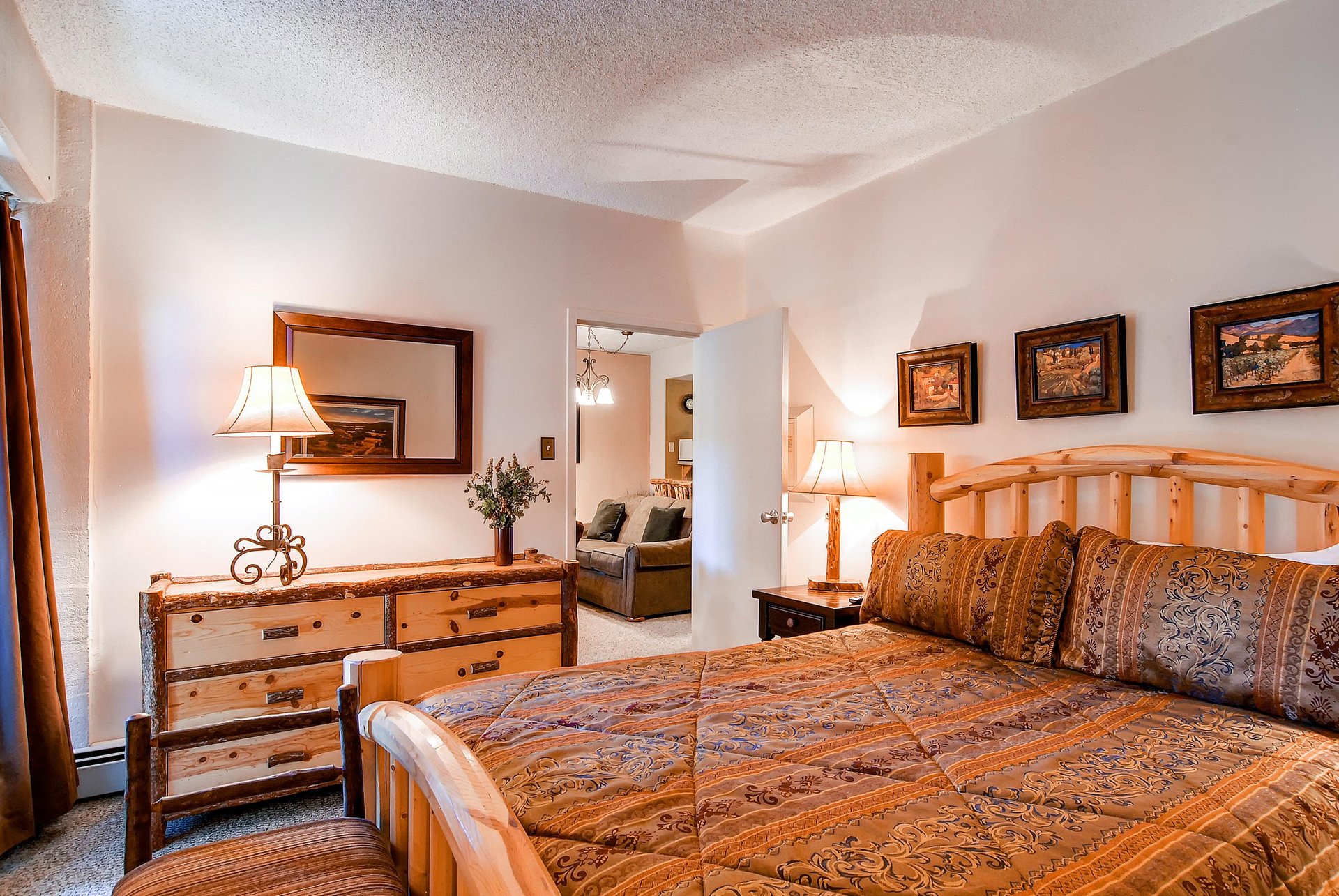 The guest bedroom with a king bed and TV.