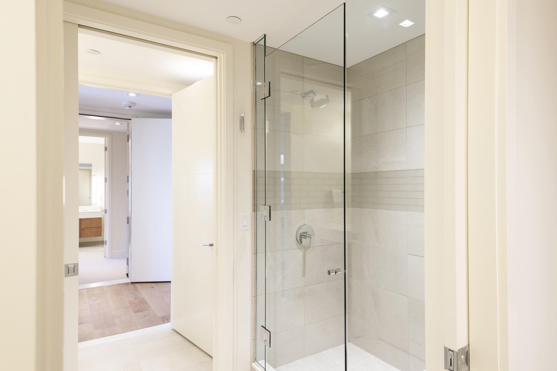 34 hallway bathroom tiled shower with glass door.