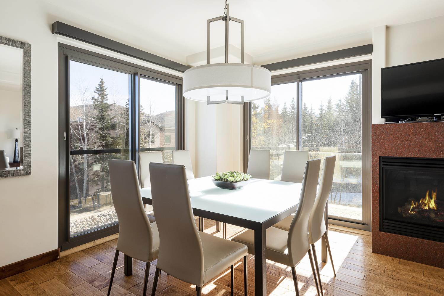 Square dining table with mountain views through the stunning window walls.