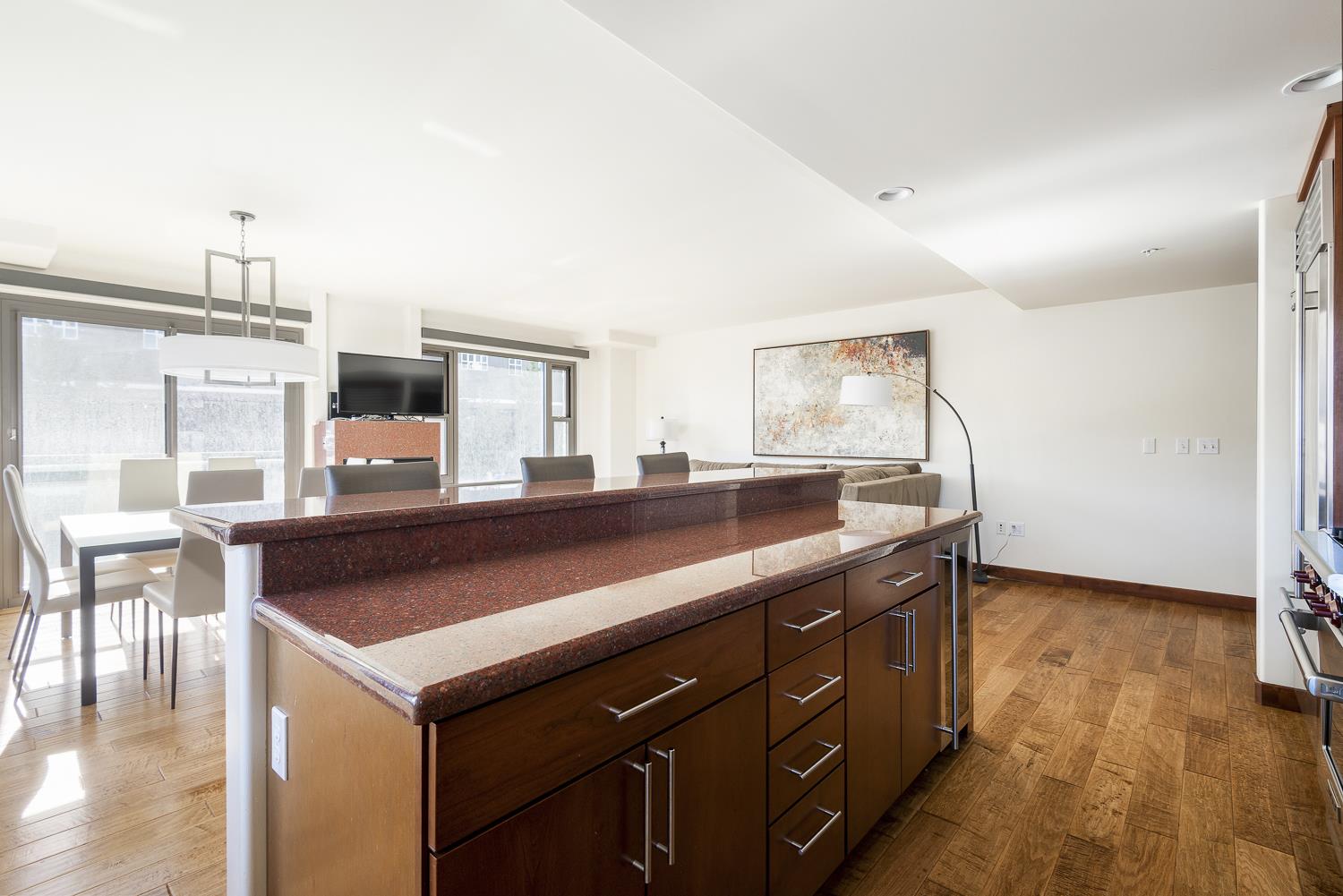 Kitchen island, red granite countertop and wood cabinets and drawers,, perfect for entertaining.