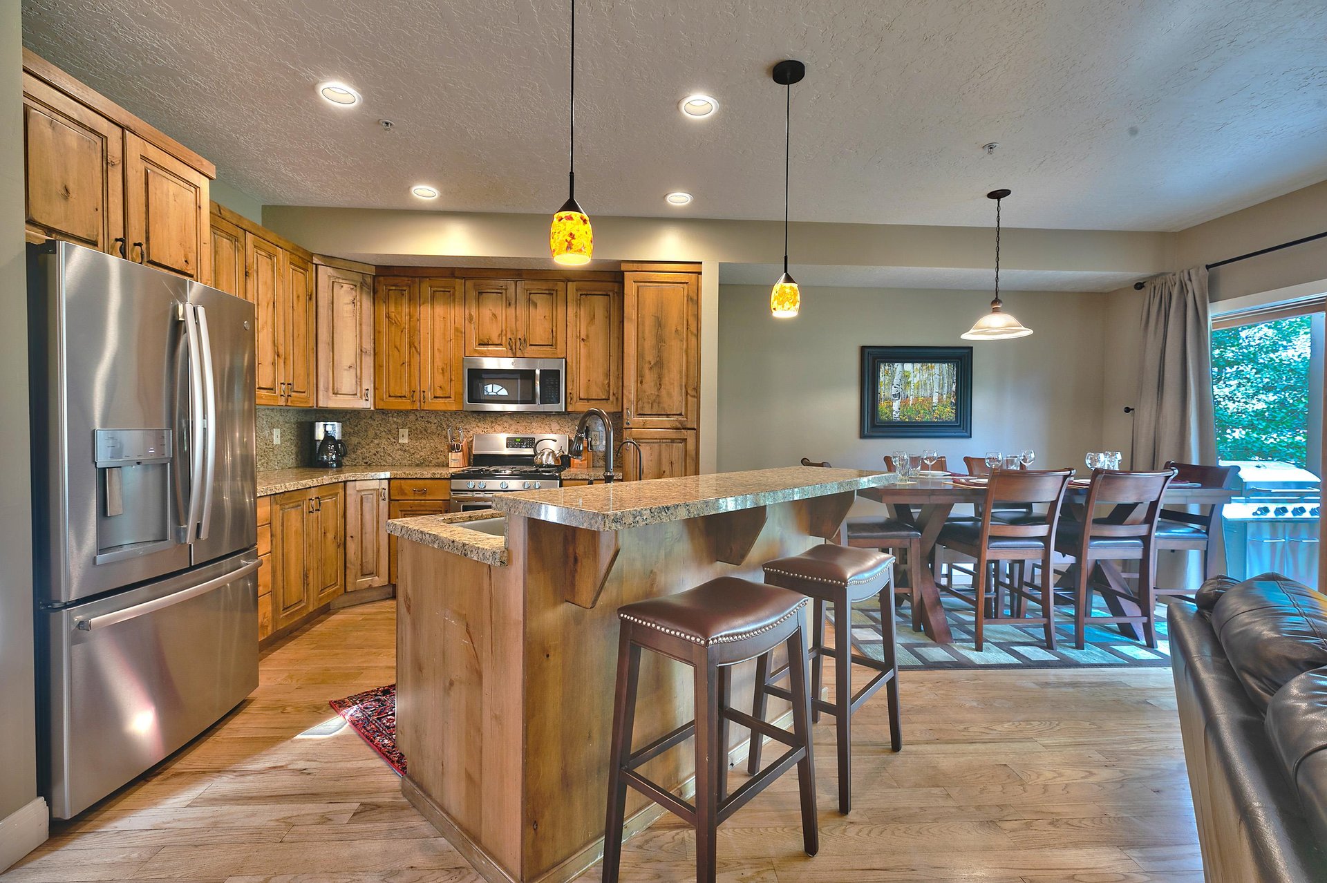 Beautiful kitchen, hardwood floors throughout and wood cabinetry with granite countertops and kitchen island.