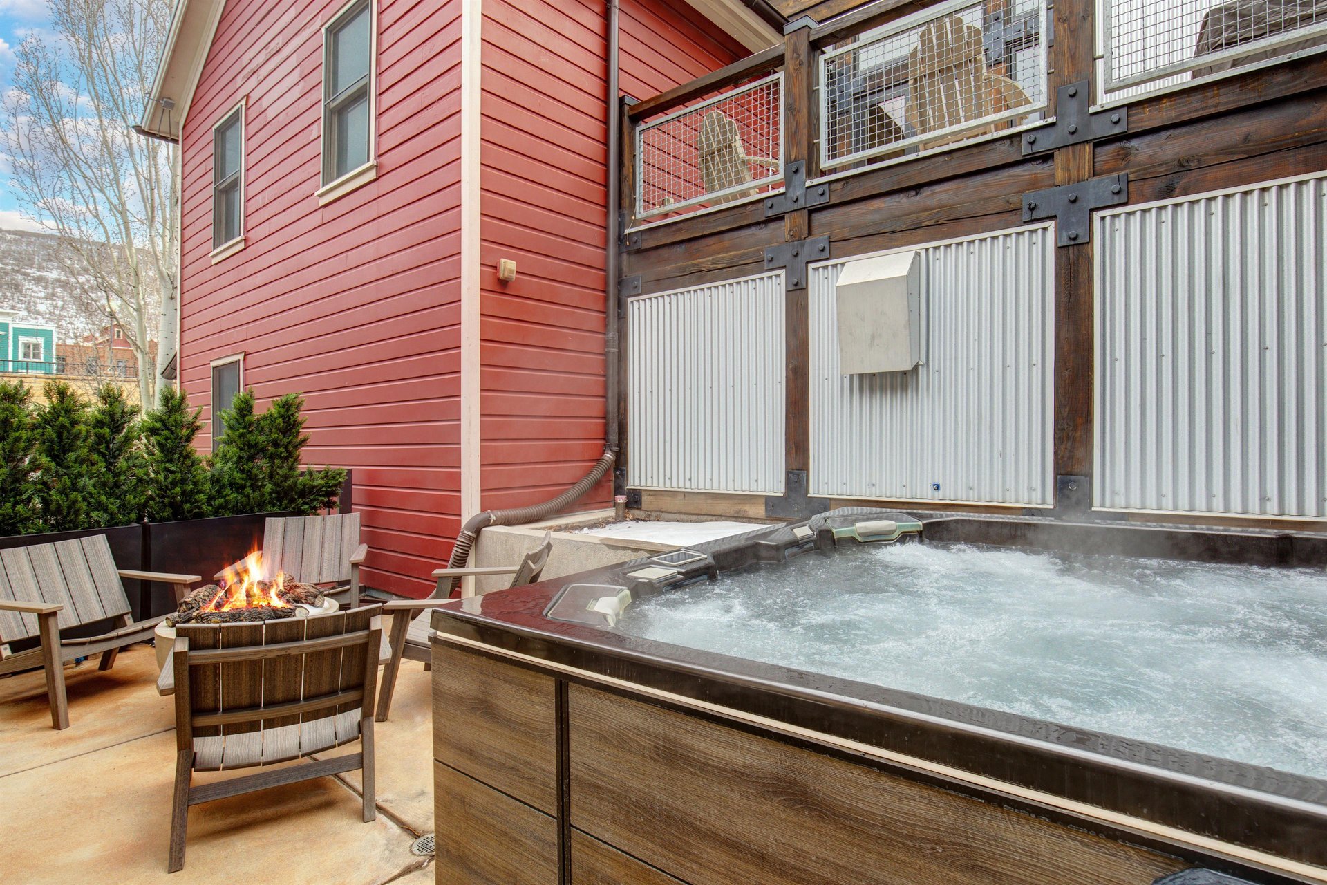 The heated patio offers a hot tub, fire table with seating for four, and BBQ gas grill.