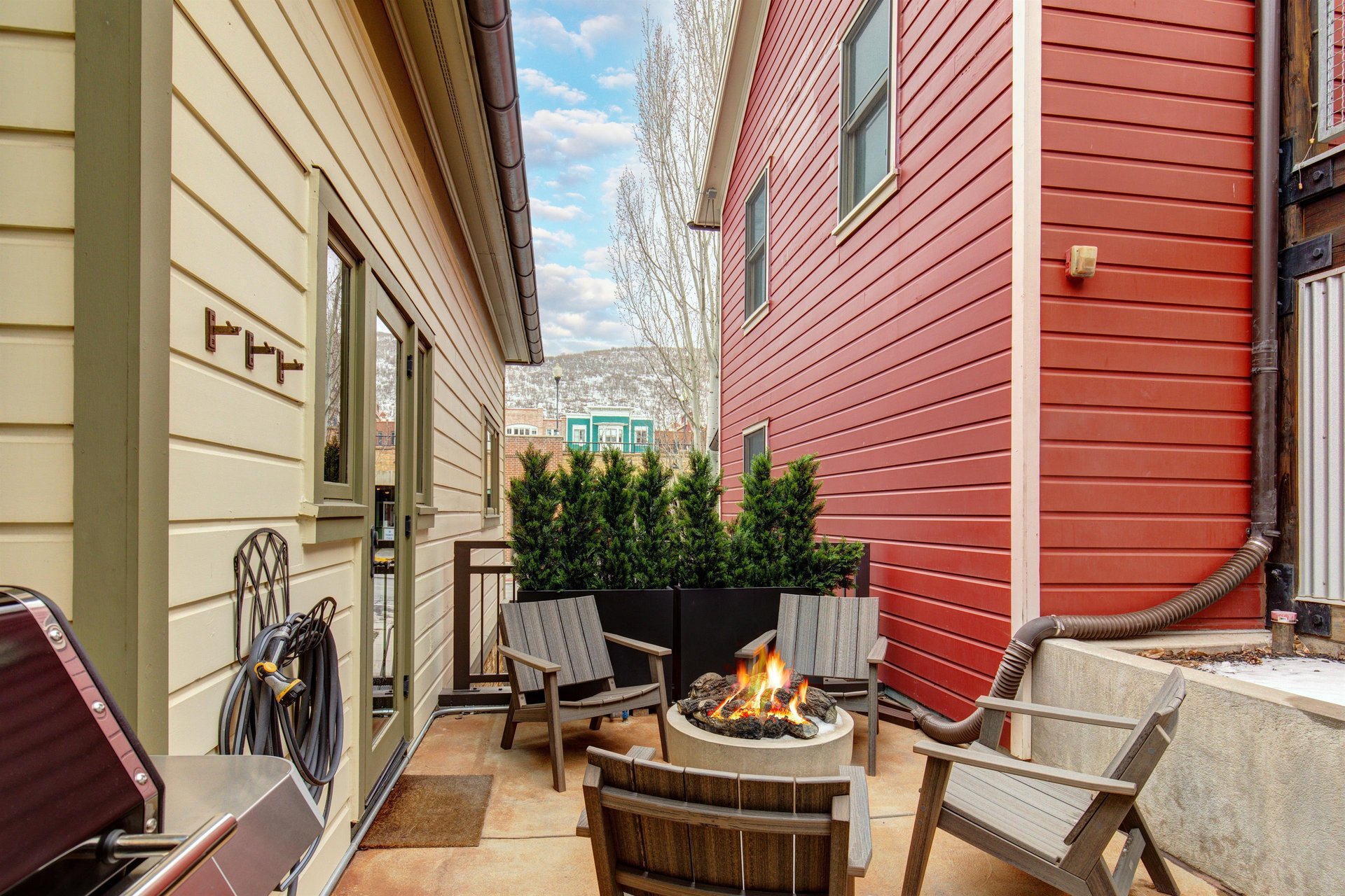 The heated patio offers a hot tub, fire table with seating for four, and BBQ gas grill.