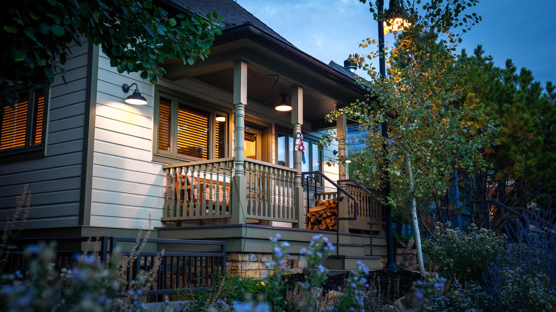Town Lift Chalet at dusk with the glow of well placed exterior lights and the glow from inside the windows.