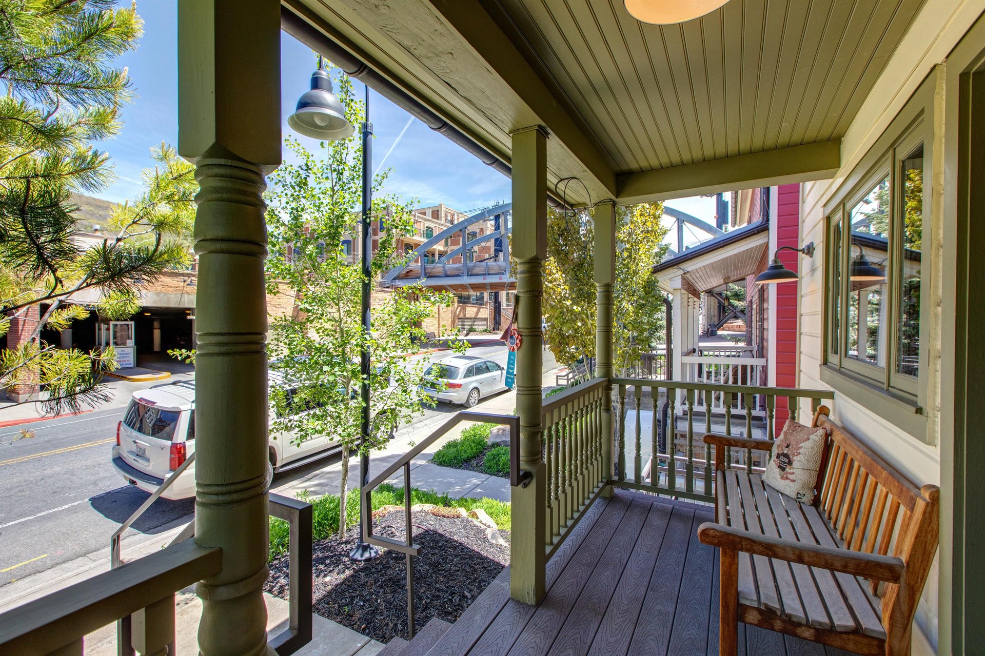The front porch has a bench and an overhanging porch for a comfortable spot to sit and relax.