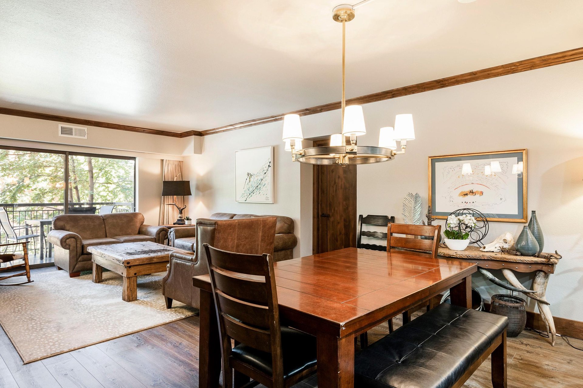Dining area with wood table, seating for six and open views into the living room and kitchen.