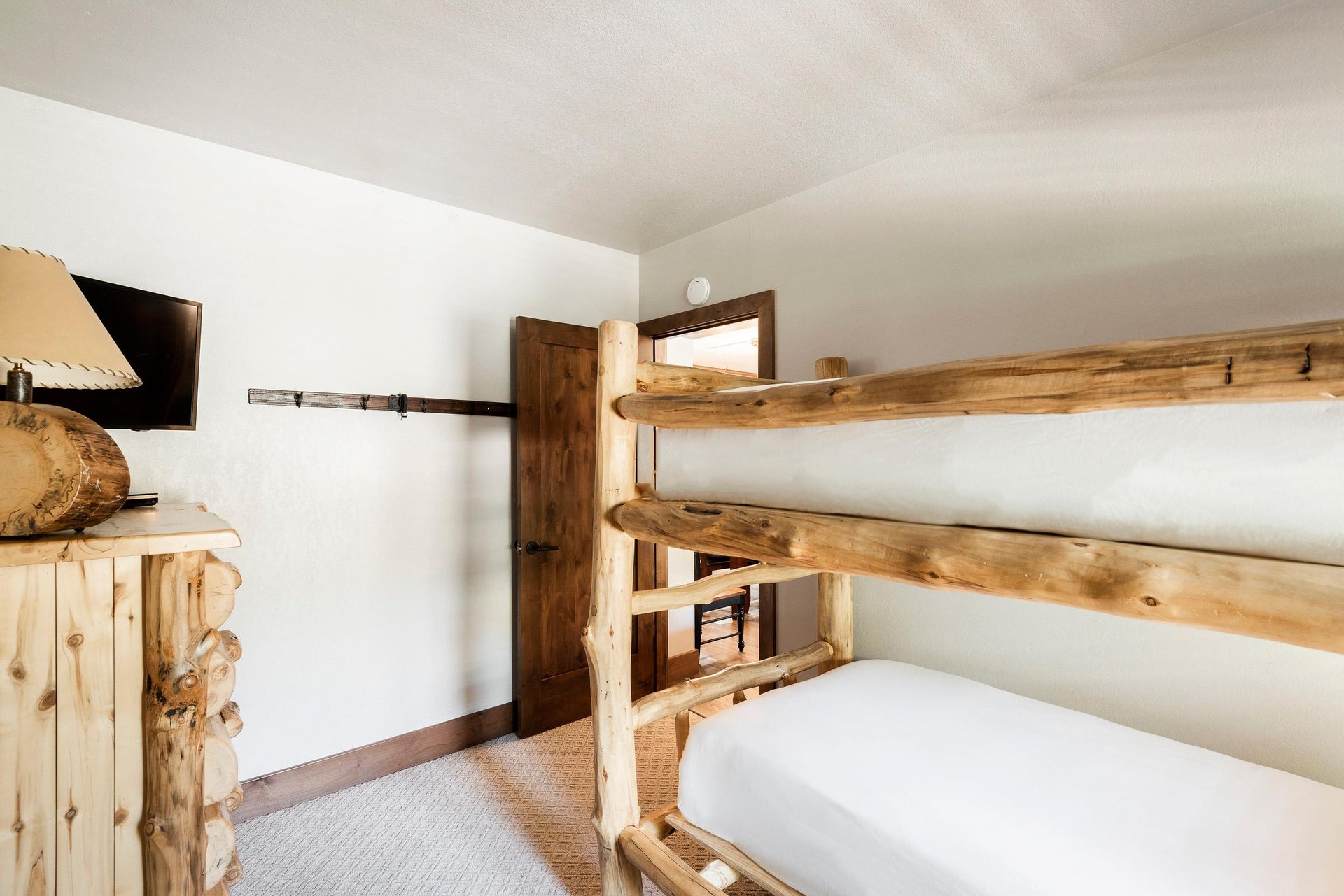 Unit 229 bedroom with rustic log bunk beds and warm wood accents.