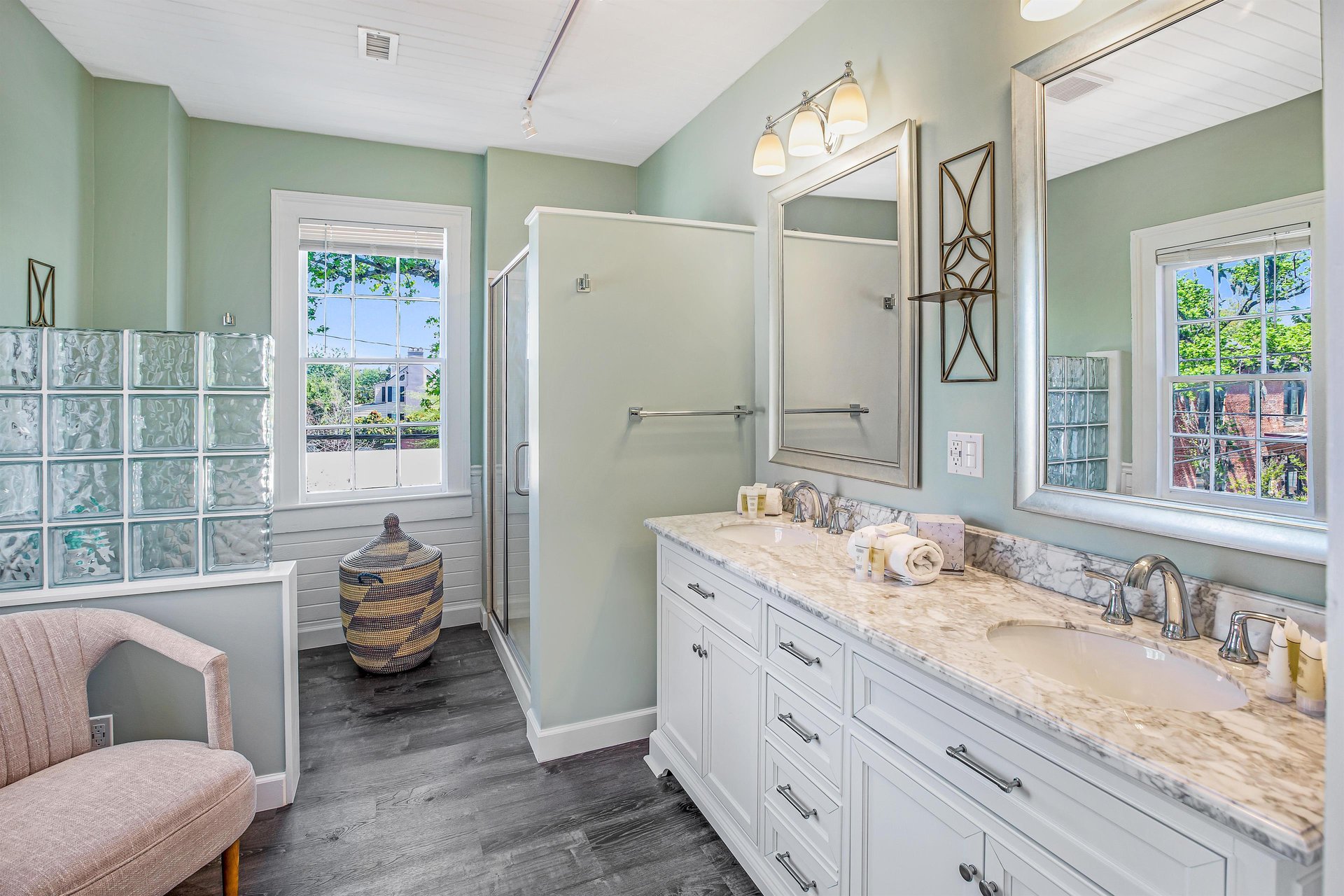 At the back of the house, youll find another bathroom, that features a large vanity, and a walkin shower.