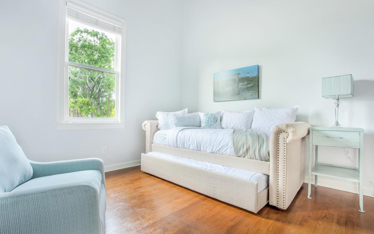 A twin bed and trundle are located in a loftlike space.
