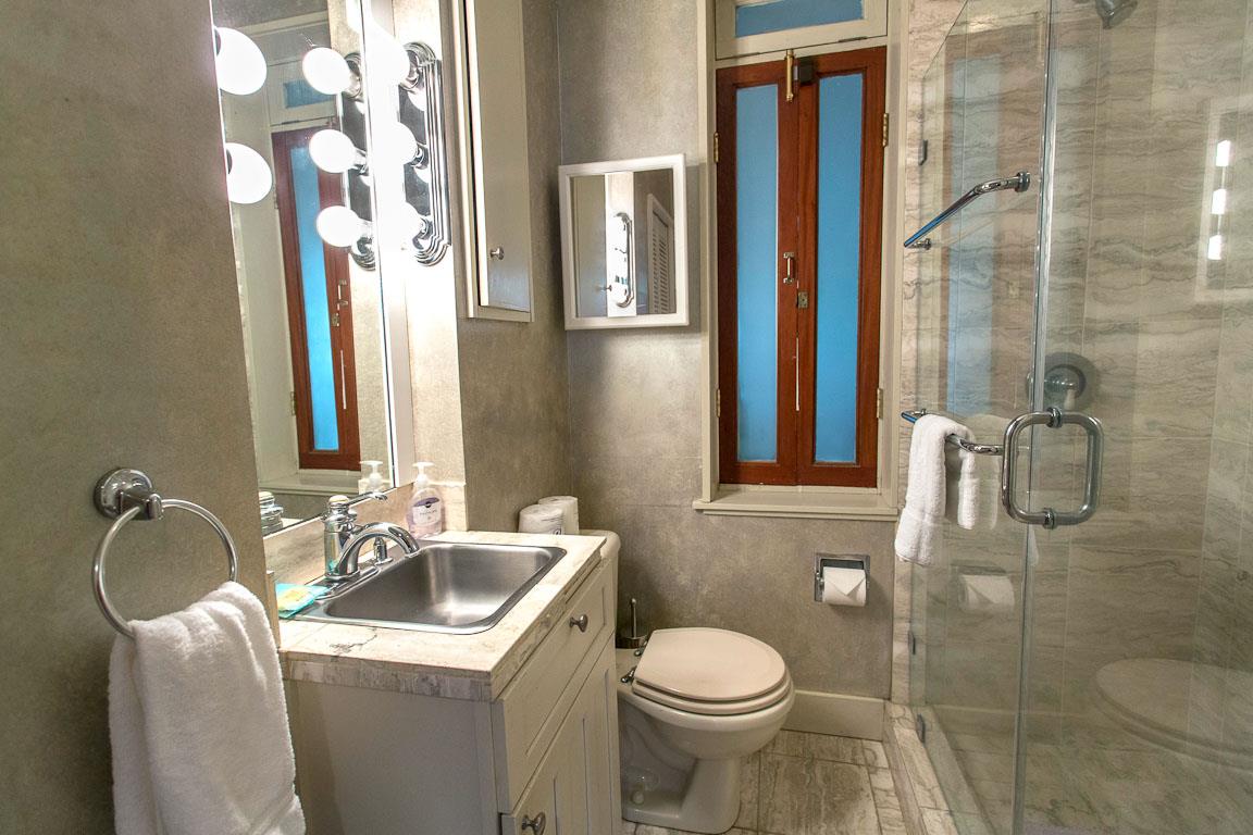 The first bath has a standing shower.