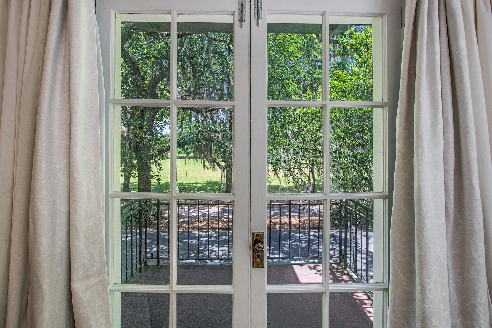 The balcony doors open to a charming space, that allow a comfortable breeze into the bedroom.