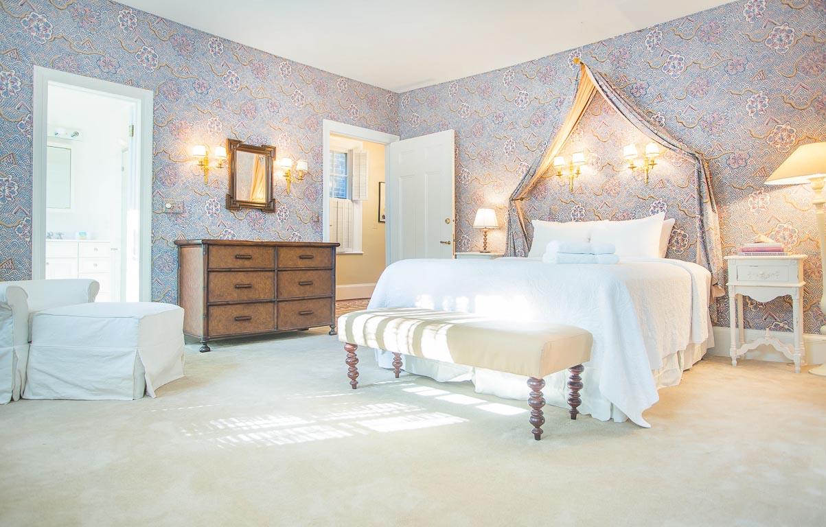 The primary bedroom has upholstered fabric walls.