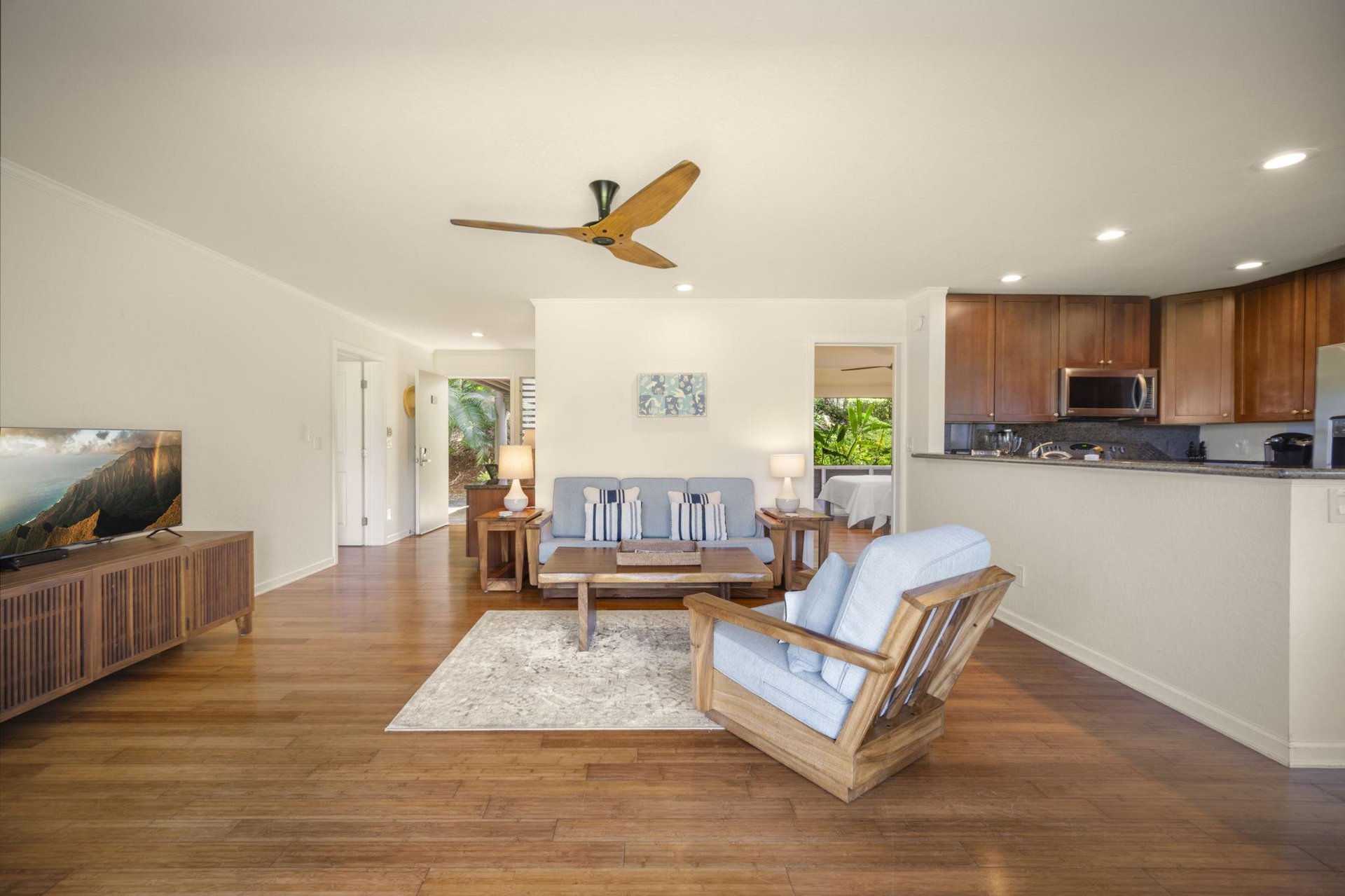View of the living room, kitchen and bedroom on the right