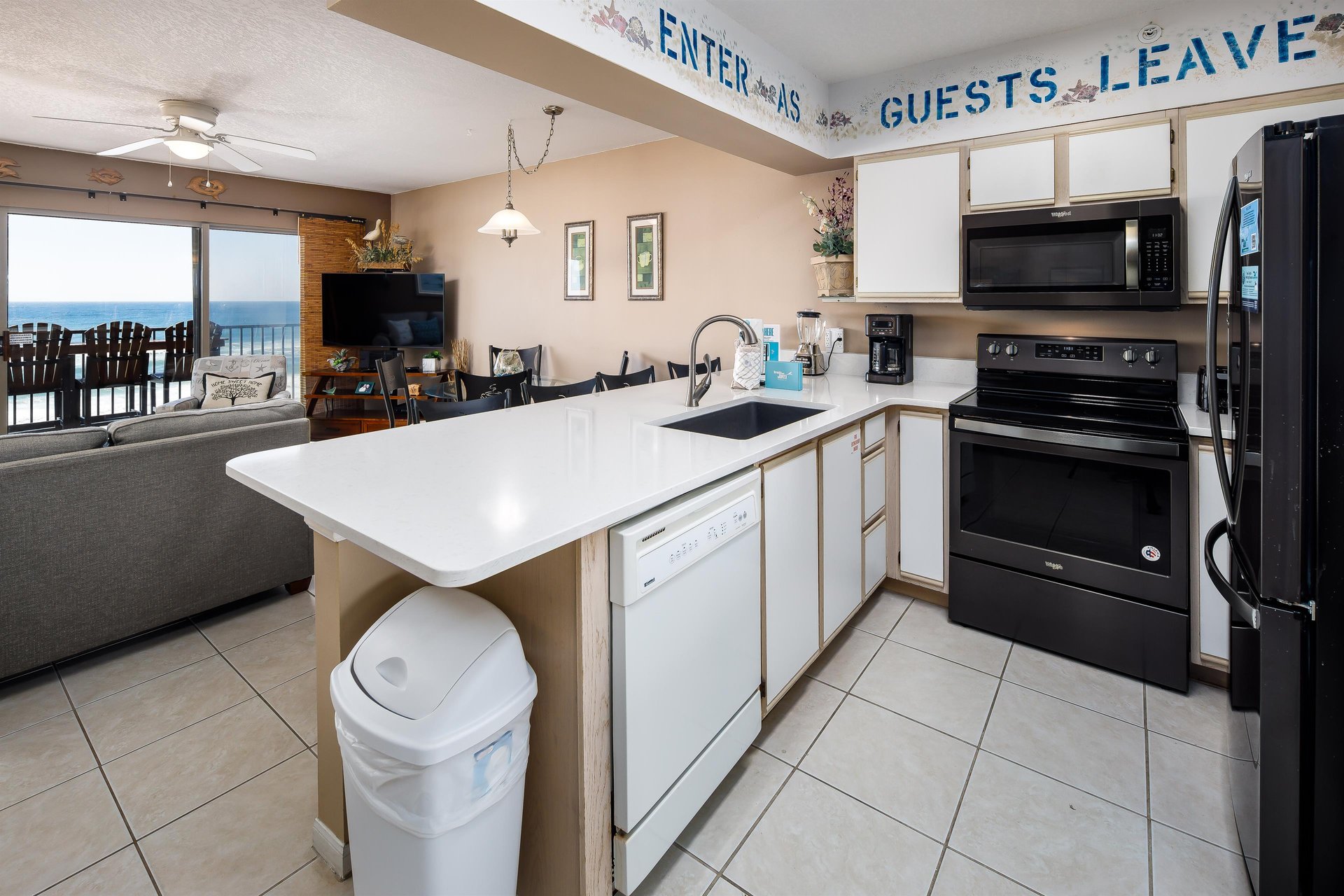 ENTER as Guests, Leave as Friends The kitchen island offers a perfect space for a quick sandwich, while the rest of the kitchen is equipped with all major appliances to make a healthy home cooked me