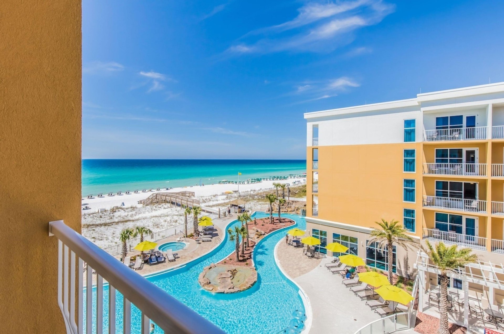 A view of the pool and beach from a balcony
