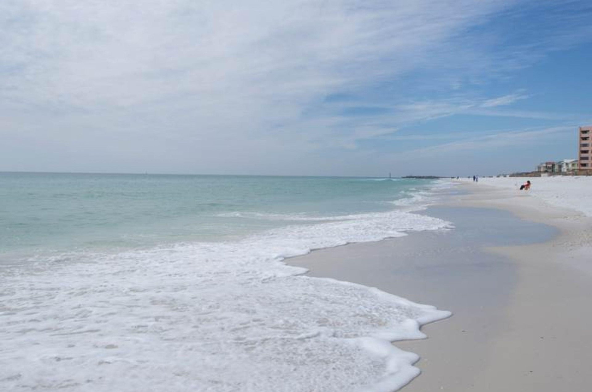 The tide rolling in on the beach adjacent to Inlet Reef Club in Destin.