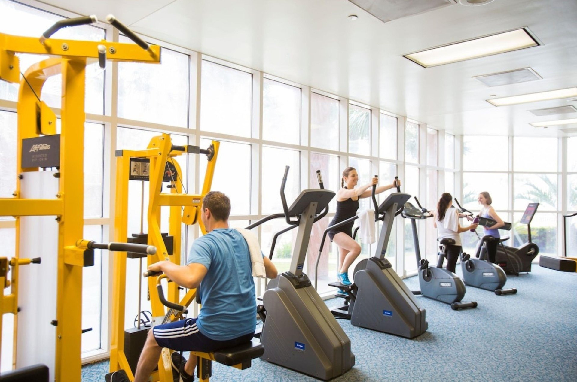 Cardio equipment next to windows in the fitness center at Perdido Beach Resort