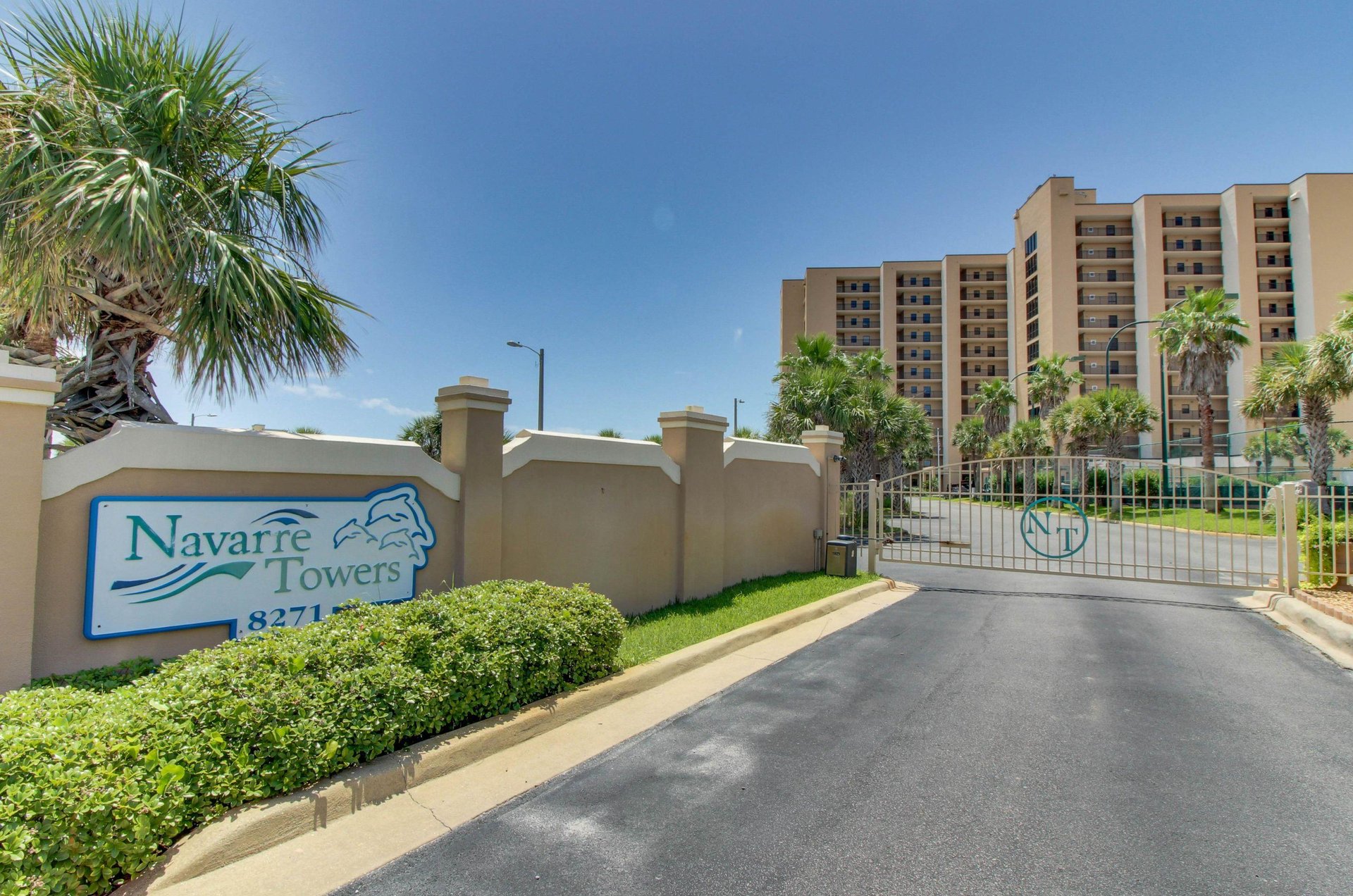 The sign for Navarre Towers and gated entrance to the property