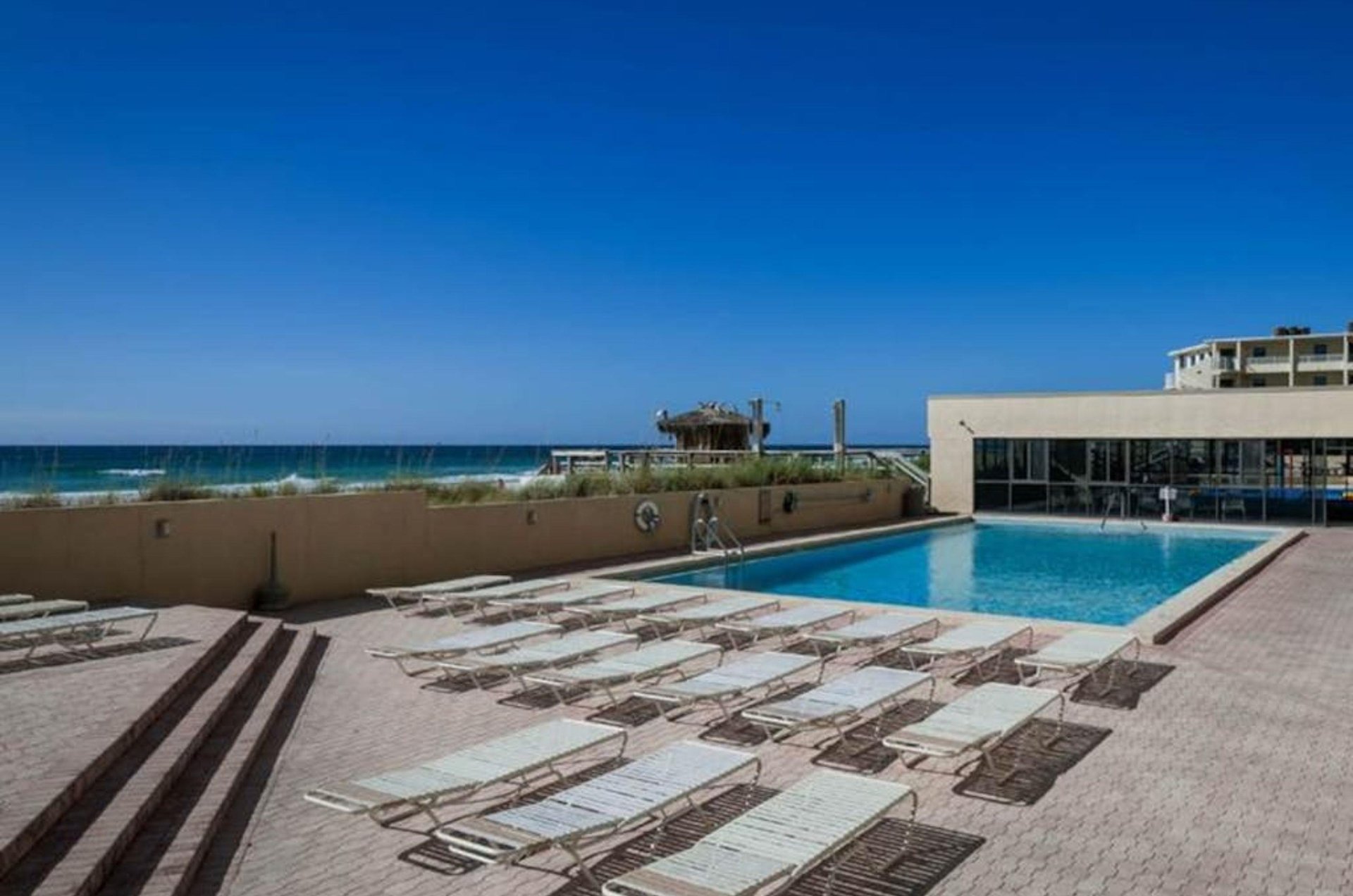 Lounge chairs next to the outdoor pool at SunDestin Beach Resort in Destin Florida