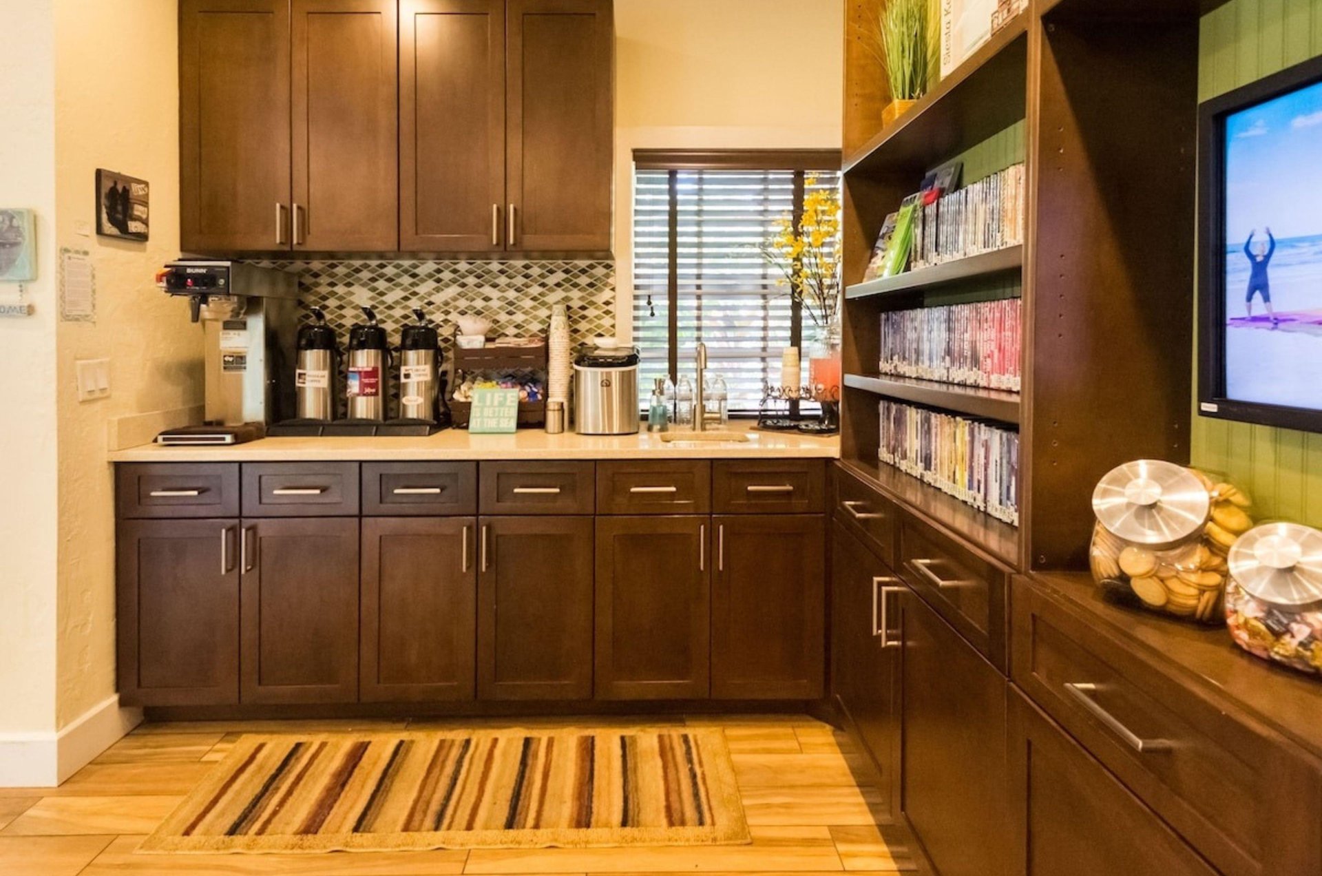 The lobby at Tropical Beach Resorts with a library and a counter with complimentary tea and coffee