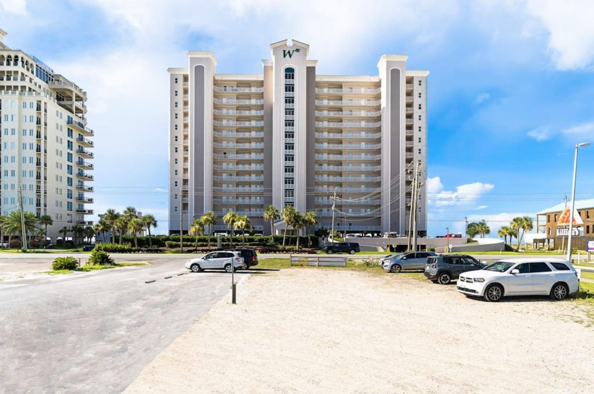 View from the street of Perdido Key with complimentary parking spaces out front