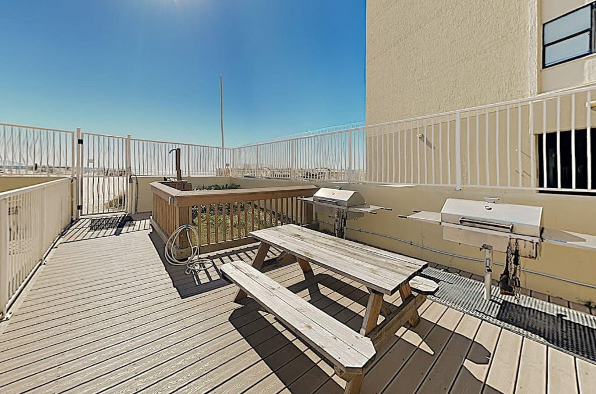 Barbecue grills next to a picnic table at Clearwater Condos in Gulf Shores Alabama