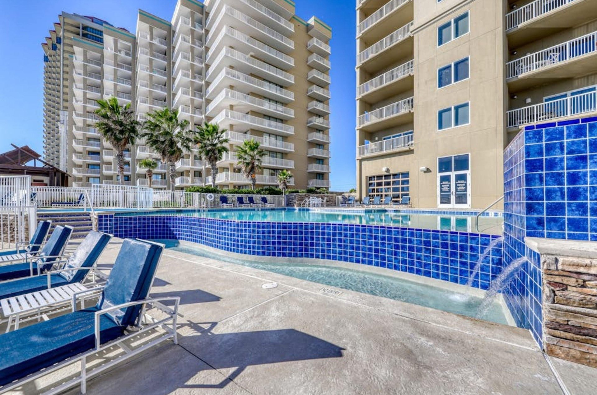 The outdoor swimming pool in front of Escapes to the Shores in Orange Beach Alabama