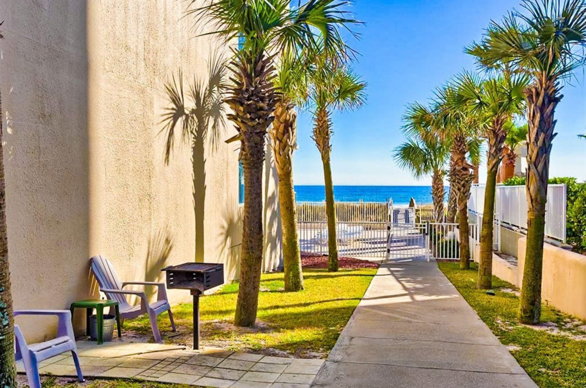 Charcoal grills next a walkway at Four Winds in Orange Beach Alabama