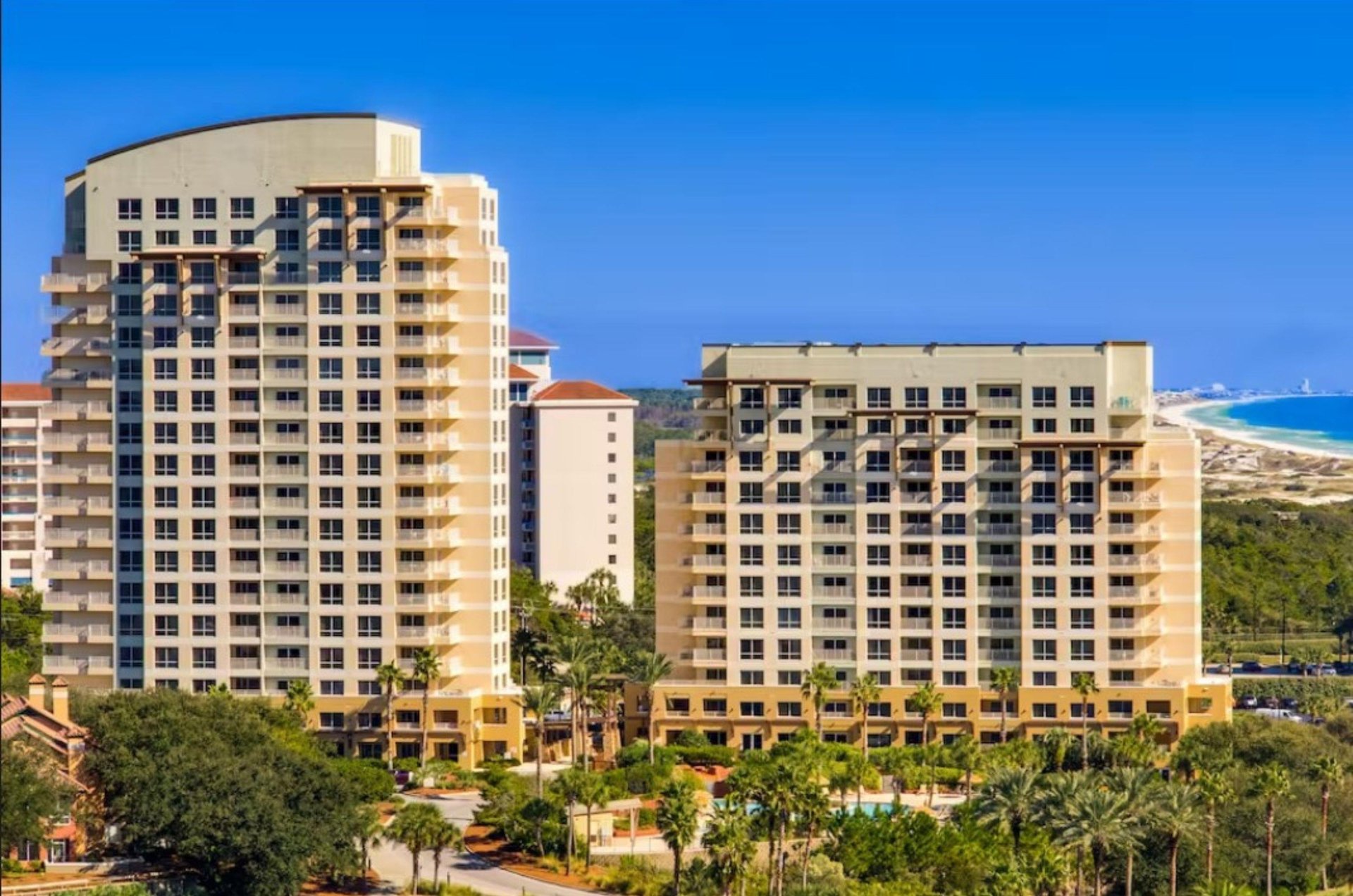 The Luaus condos feature balconies overlooking the resort pool and offering sweeping views of the Gulf beyond