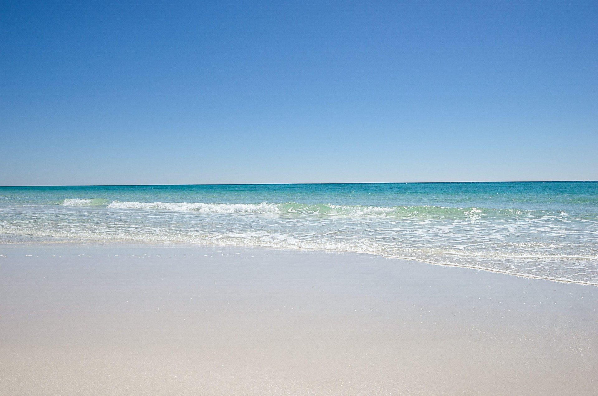 The sun shimmers on the propertys adjacent beach.
