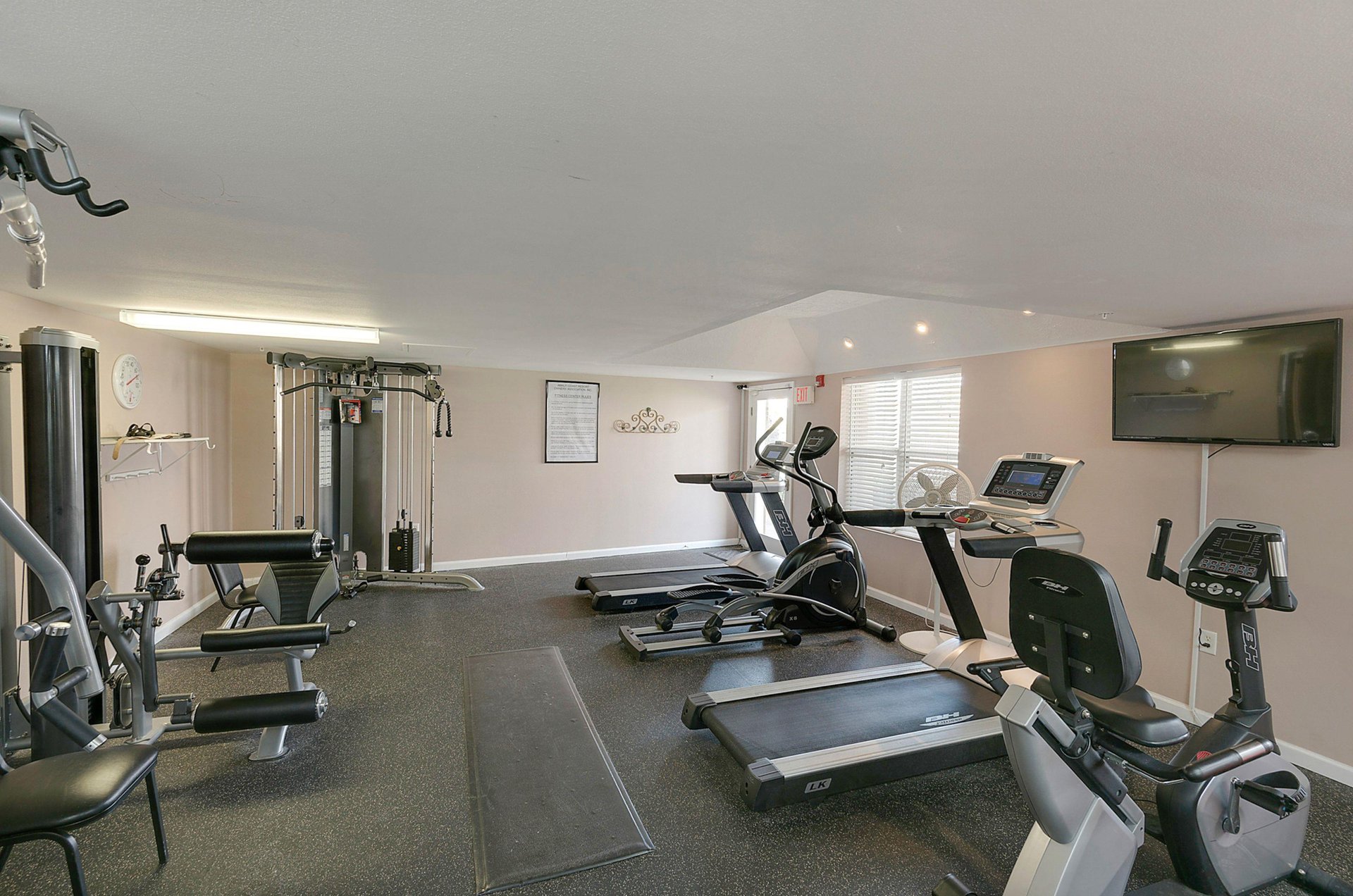The fitness room has a variety of exercise machines to cover upper and lower body workouts, as well as a treadmill for cardio.