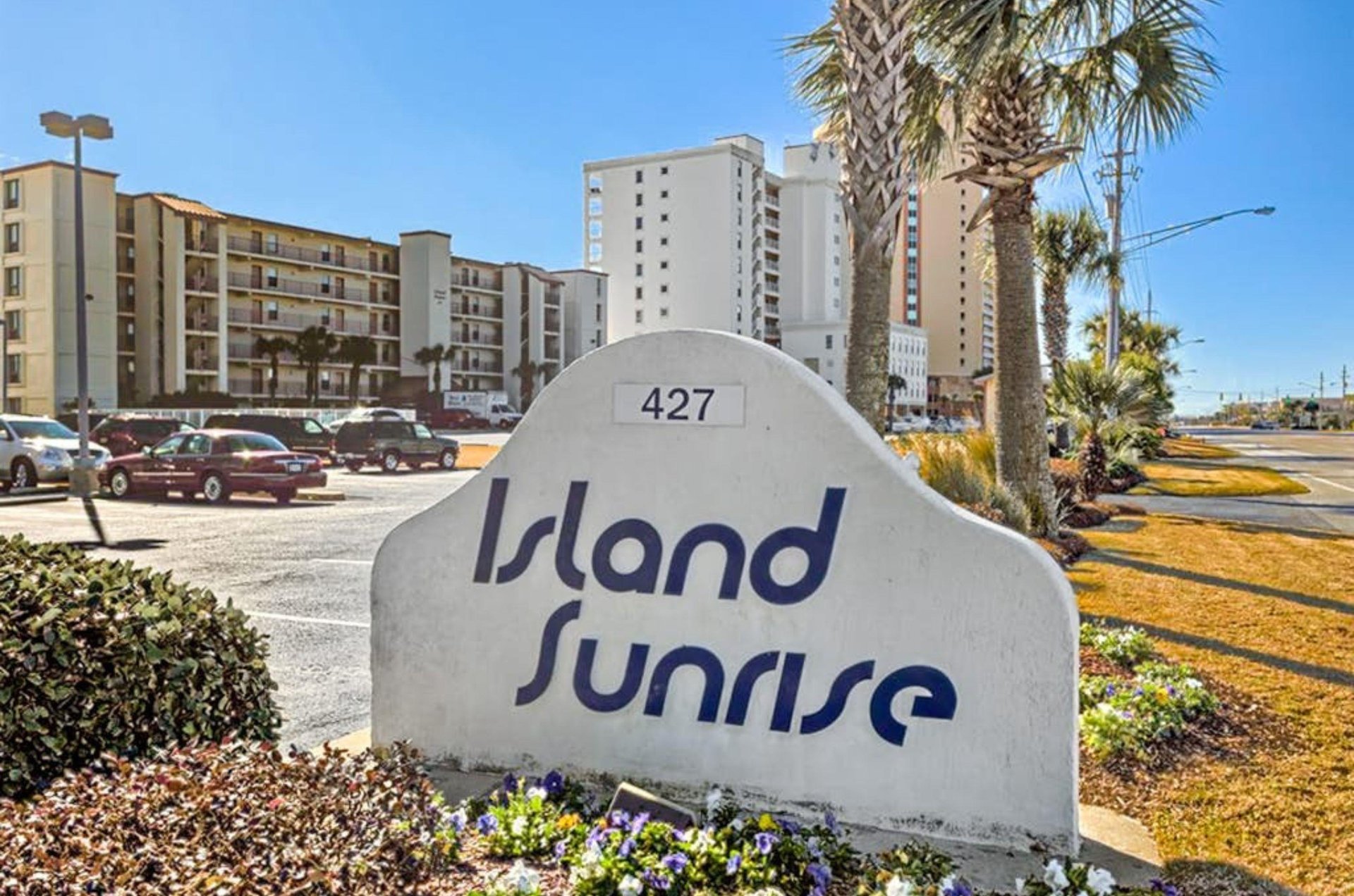 View from the street of Island Sunrise with the propertys entry sign out front
