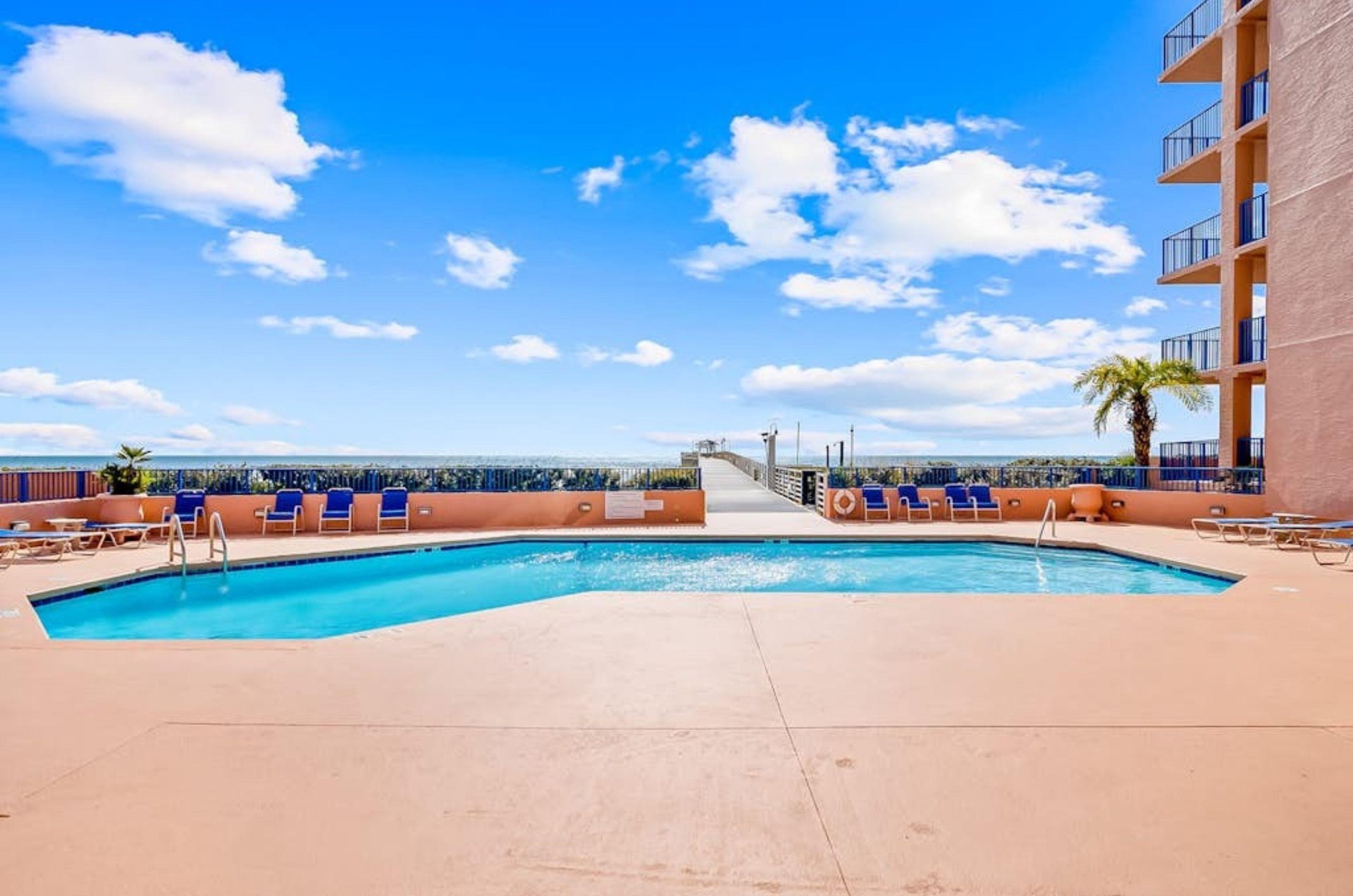 The outdoor pool and spacious pool deck at Four Seasons in Orange Beach Alabama