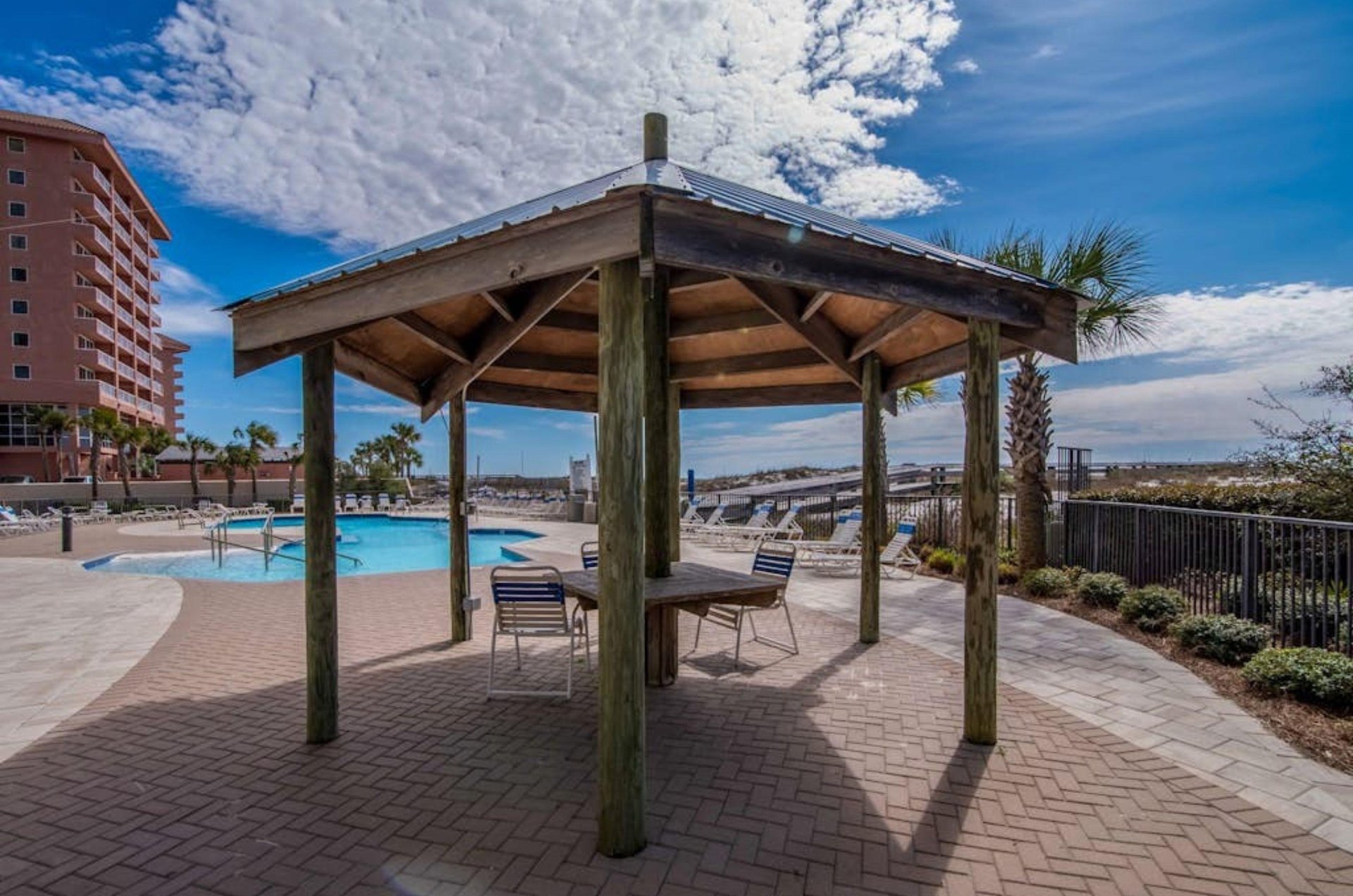 A covered table on the pool deck at Phoenix II in Orange Beach Alabama