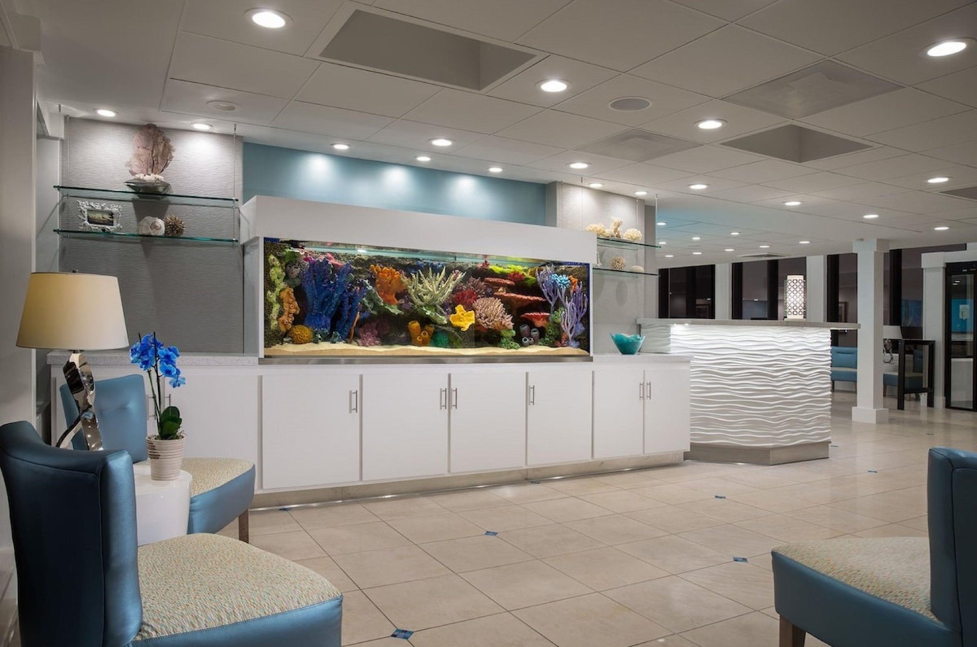 The lobby at Bilmar Beach Resort with a large fishtank next to the reception desk