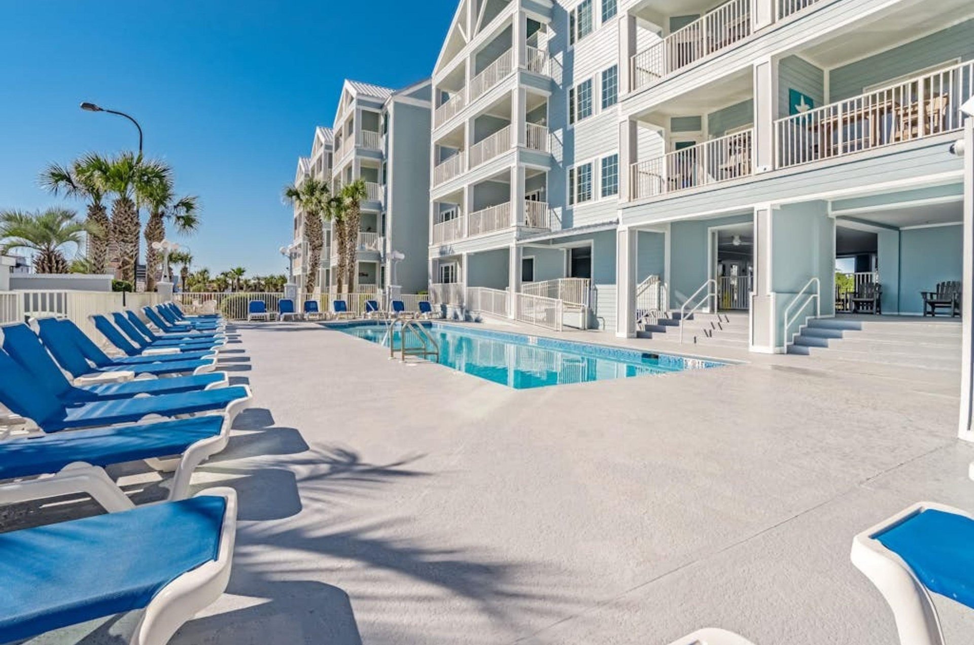 Lounge chairs next to the outdoor swimming pool at Grand Caribbean in Orange Beach Alabama