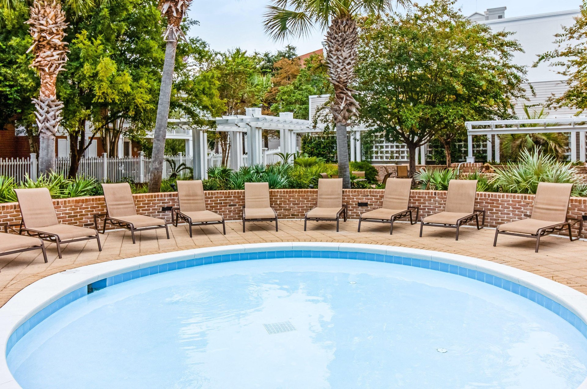 A Sandestin swimming pool with lounge chairs.
