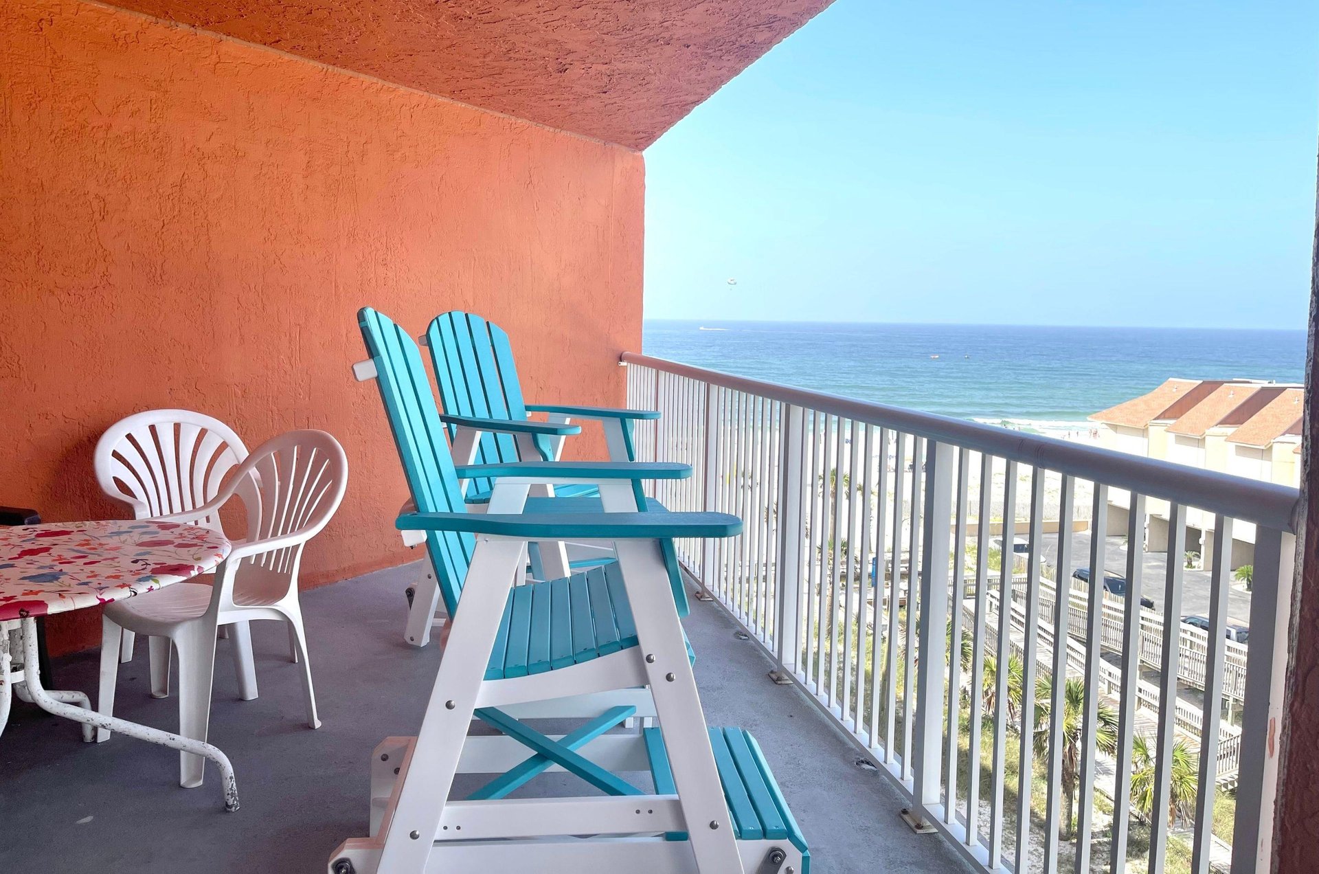 Chairs and table on a private balcony overlooking the Gulf of Mexico