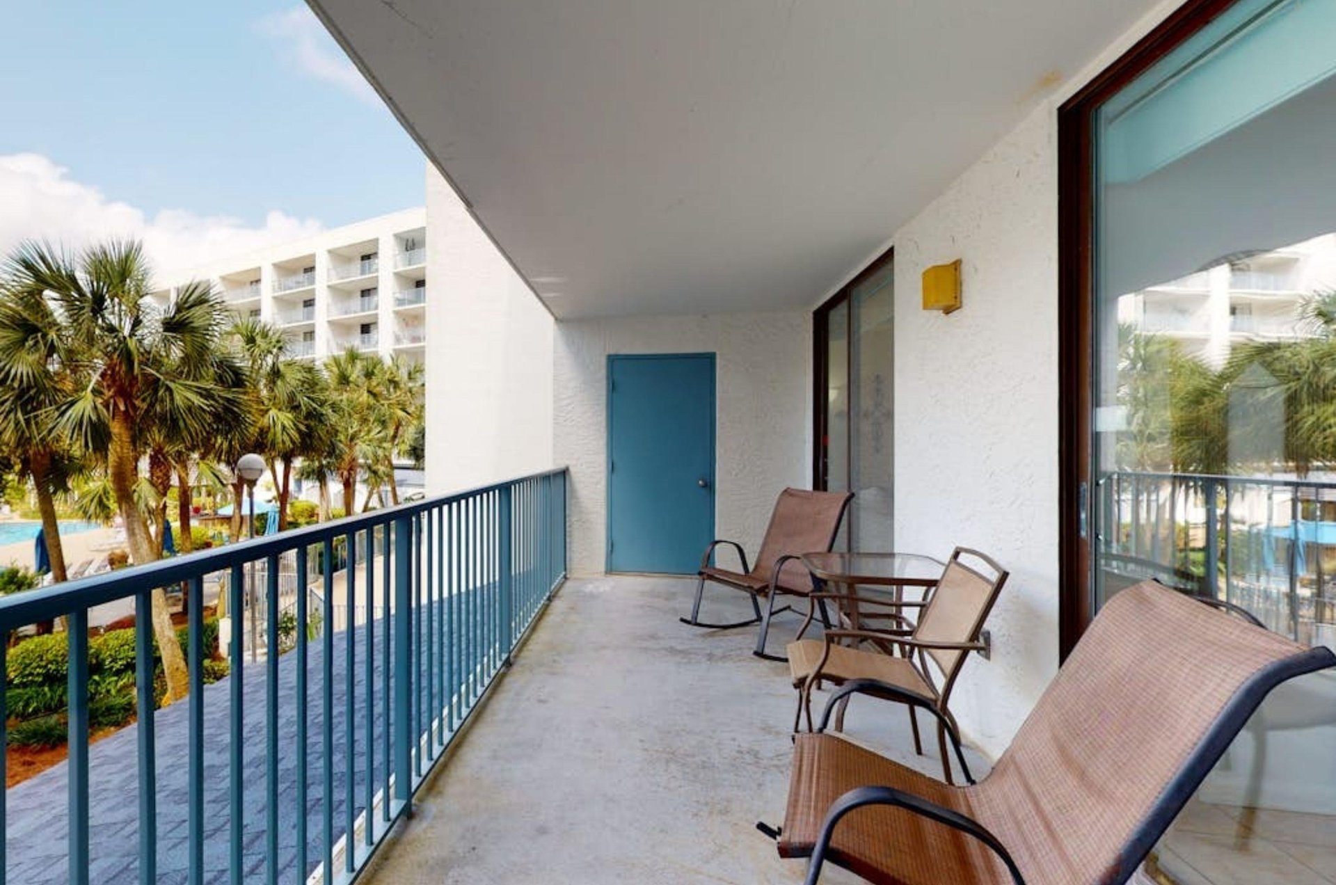 A private balcony with chairs and a small table at Gulf Shores Surf and Racquet Club in Gulf Shores Alabama
