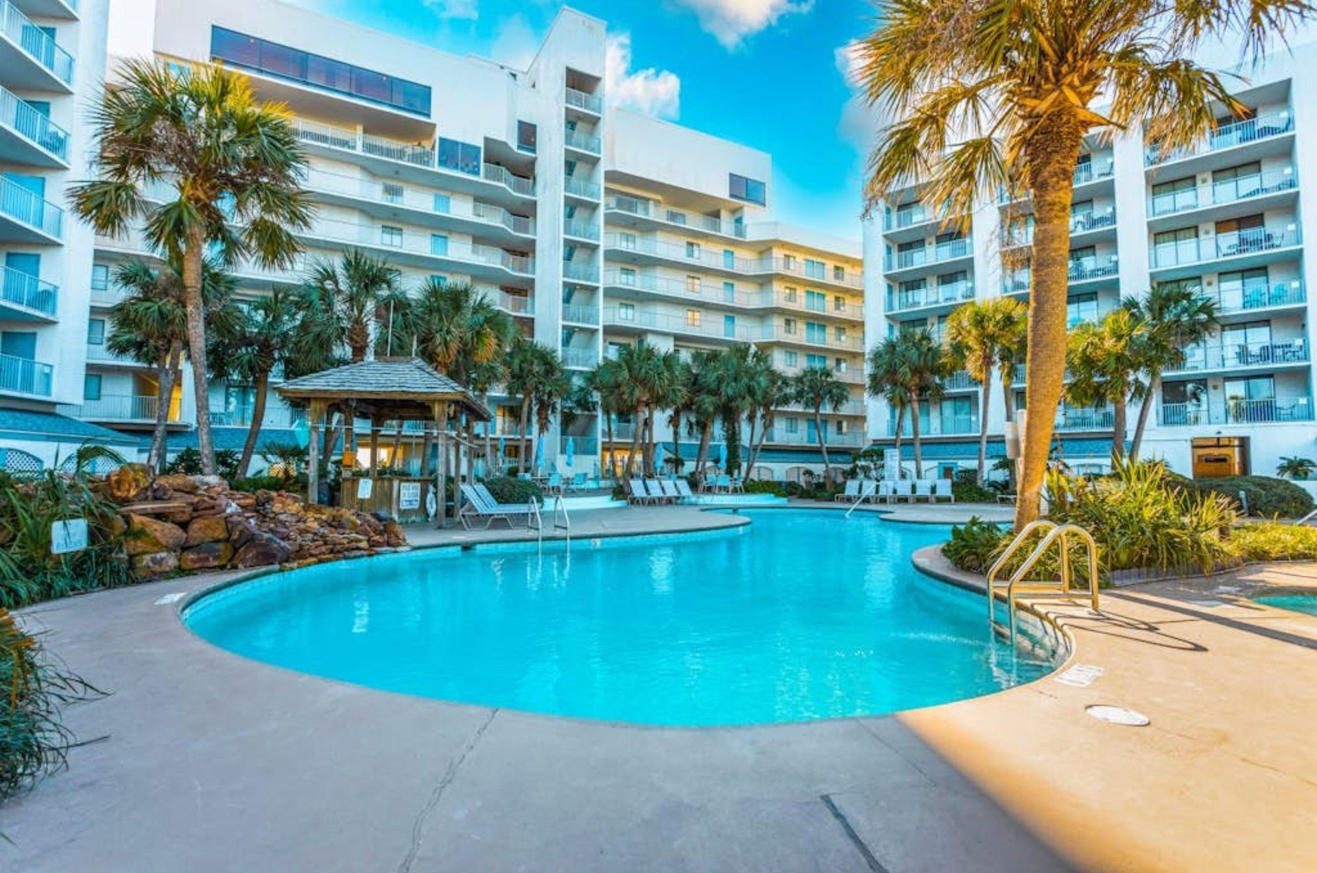 The large outdoor pool and pool deck inf front of Gulf Shores Surf and Racquet Club in Gulf Shores Alabama