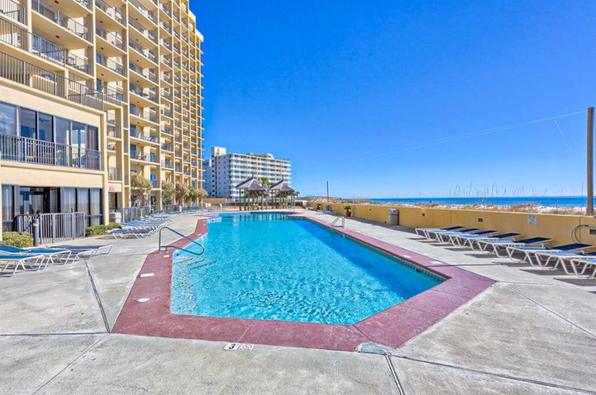 The outdoor swimming pool in front of Phoenix V in Orange Beach Alabama