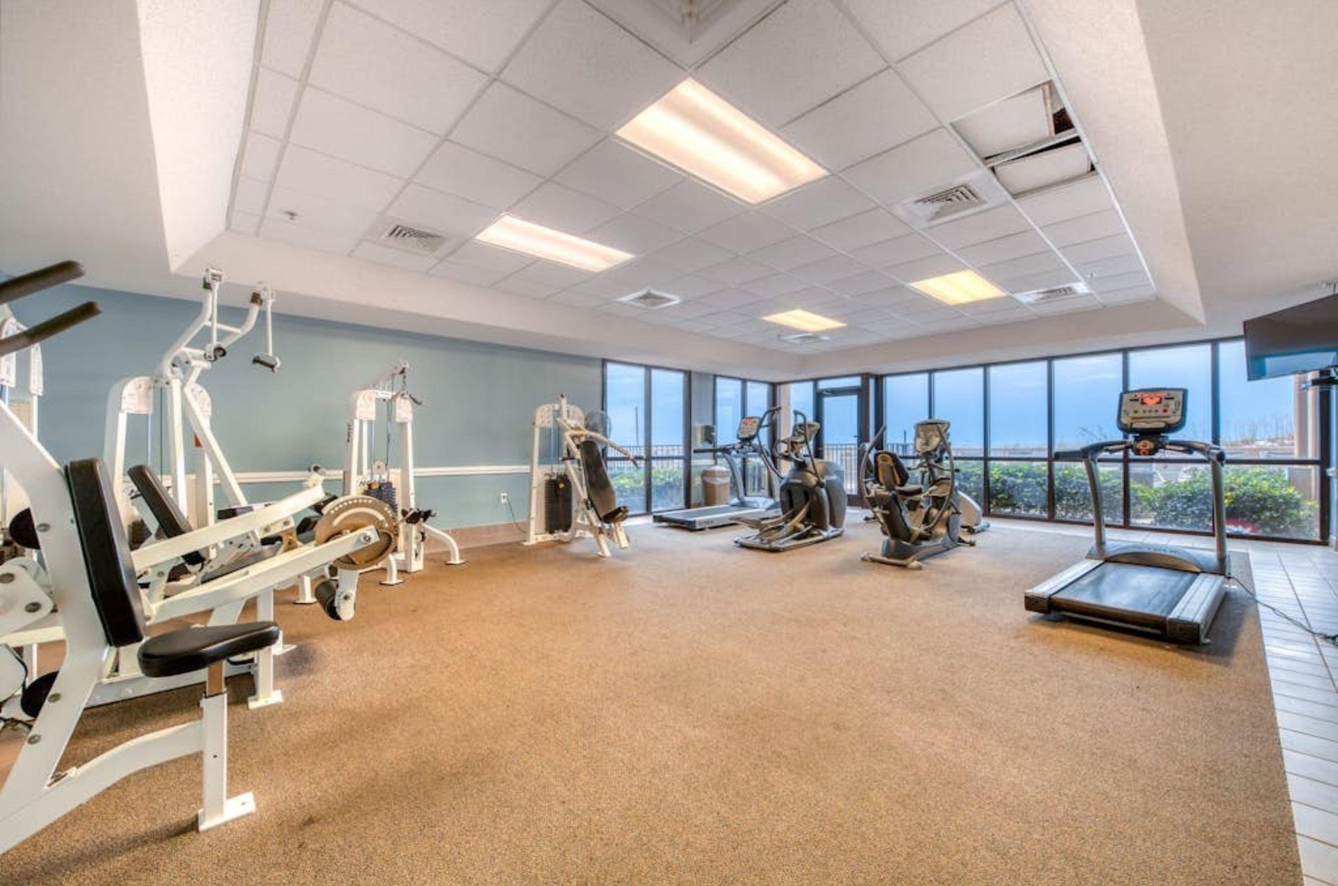 Strength and cardio equipment in the gym at Phoenix V in Orange Beach Alabama