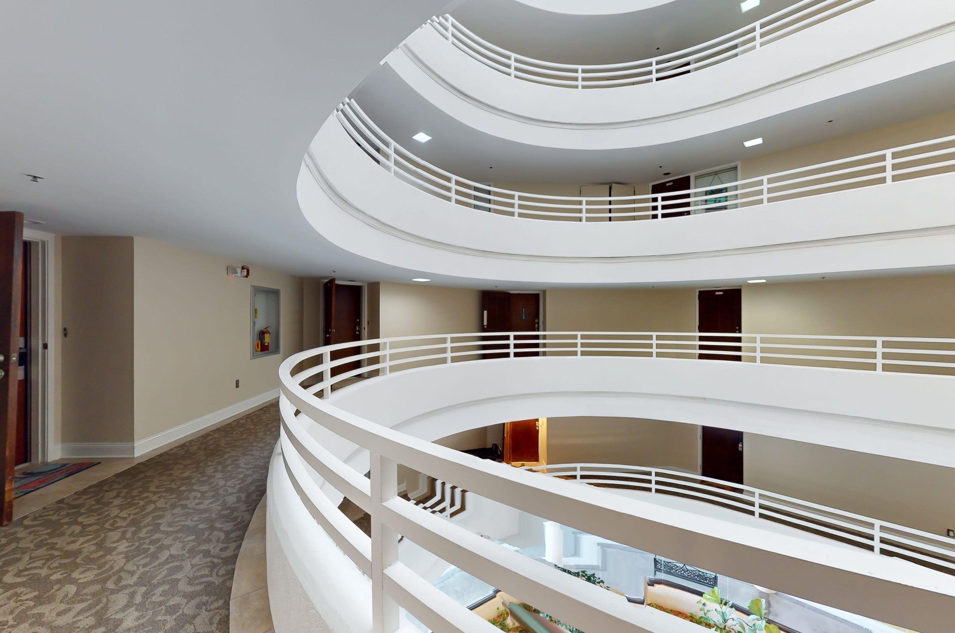 Condo entrances open from hallways encircling an atrium.