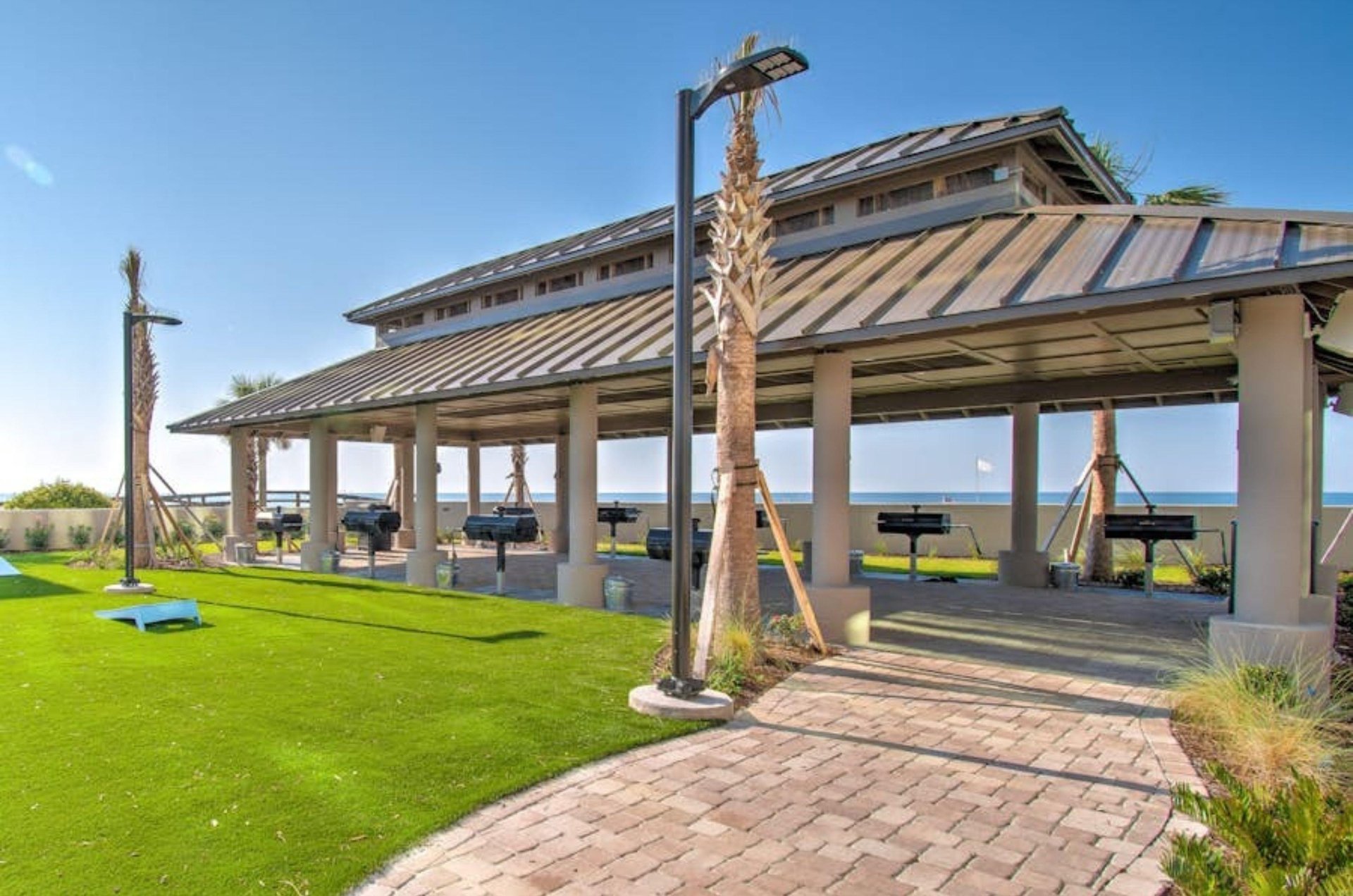 The outdoor patio with grills and tables at Phoenix West II in Orange Beach Alabama