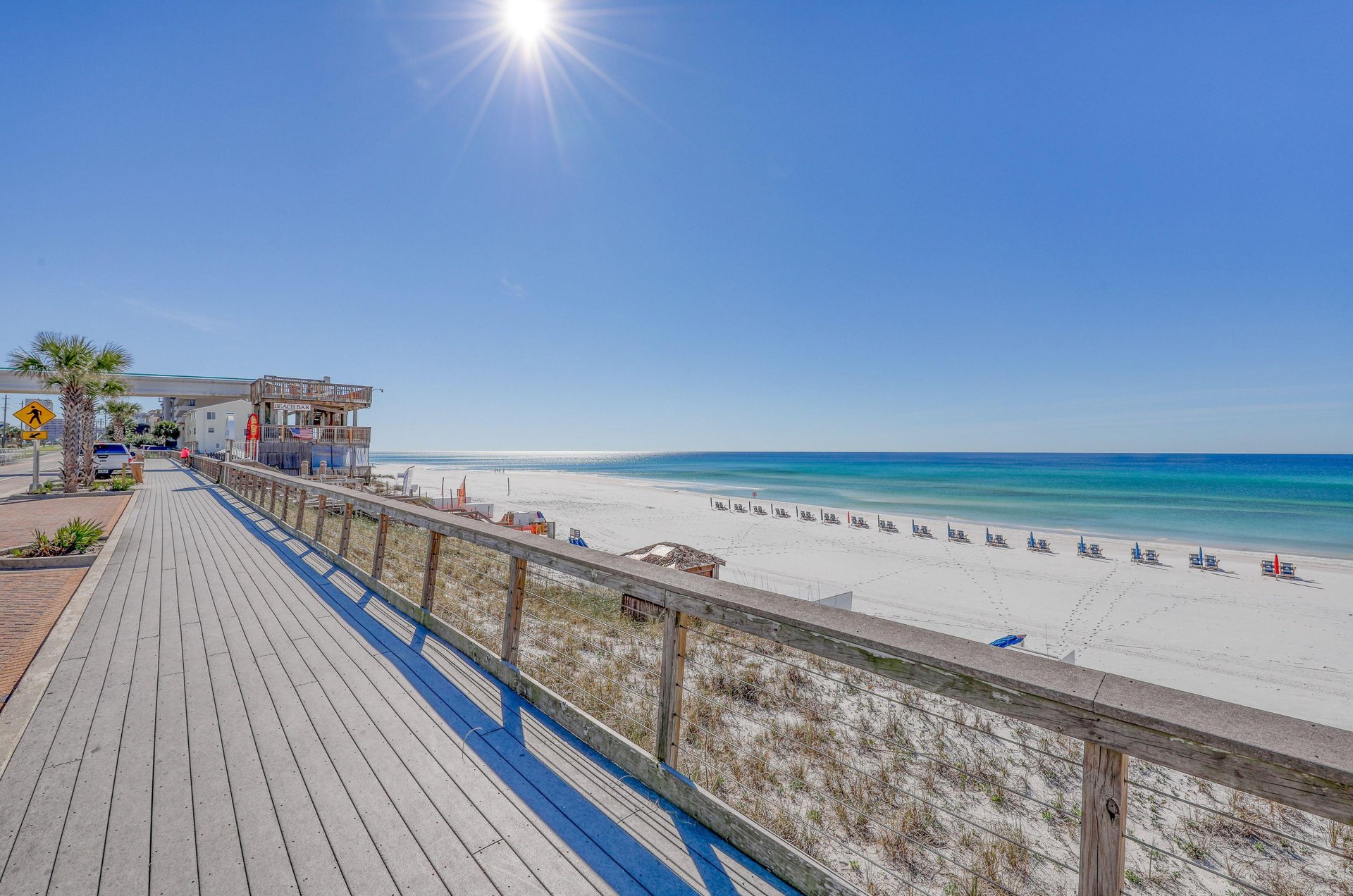 A boardwalk and Beach Bar overlook the beach.