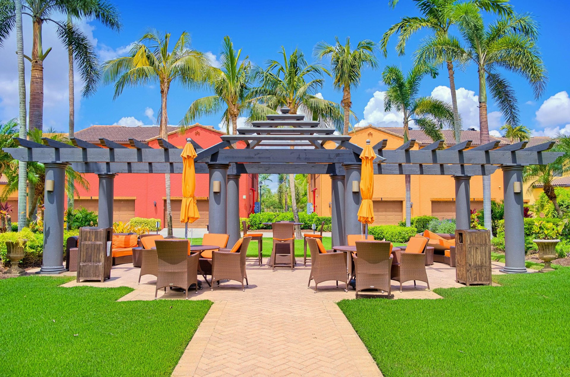A brightly colored Fort Myers rental condo with an outdoor commonarea patio.