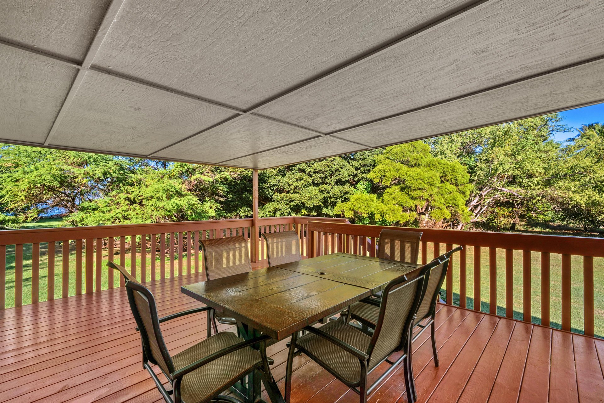 Lanai area is surrounded by lush greenery